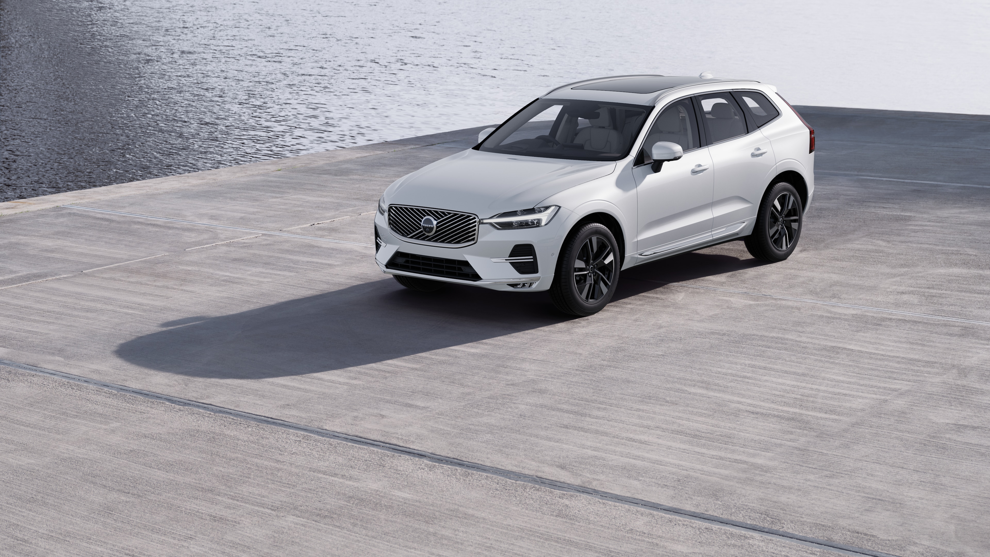 Volvo car exterior in three-quarter view against an industrial concrete wall background.