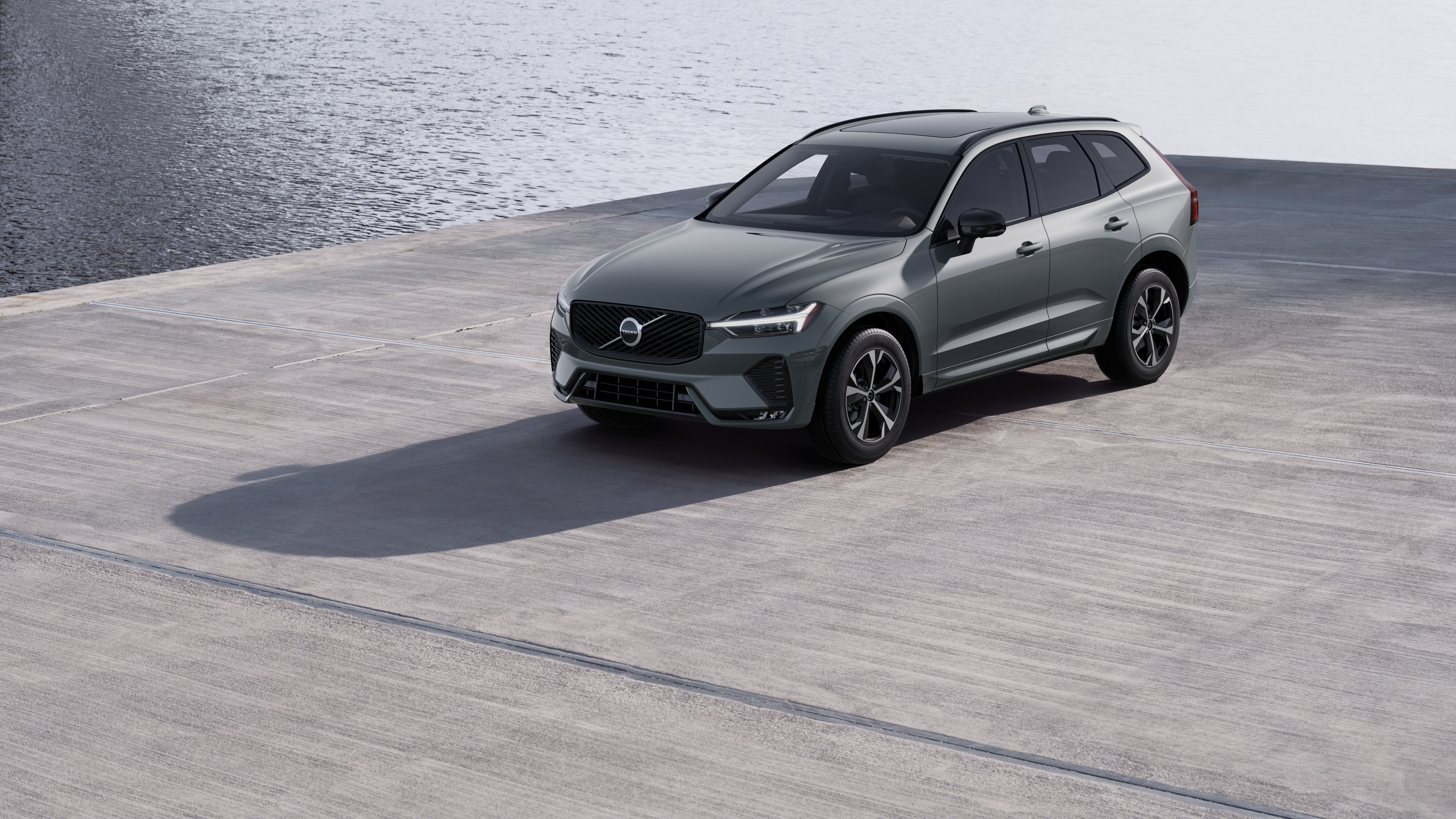 Volvo car exterior in three-quarter view against an industrial concrete wall background.