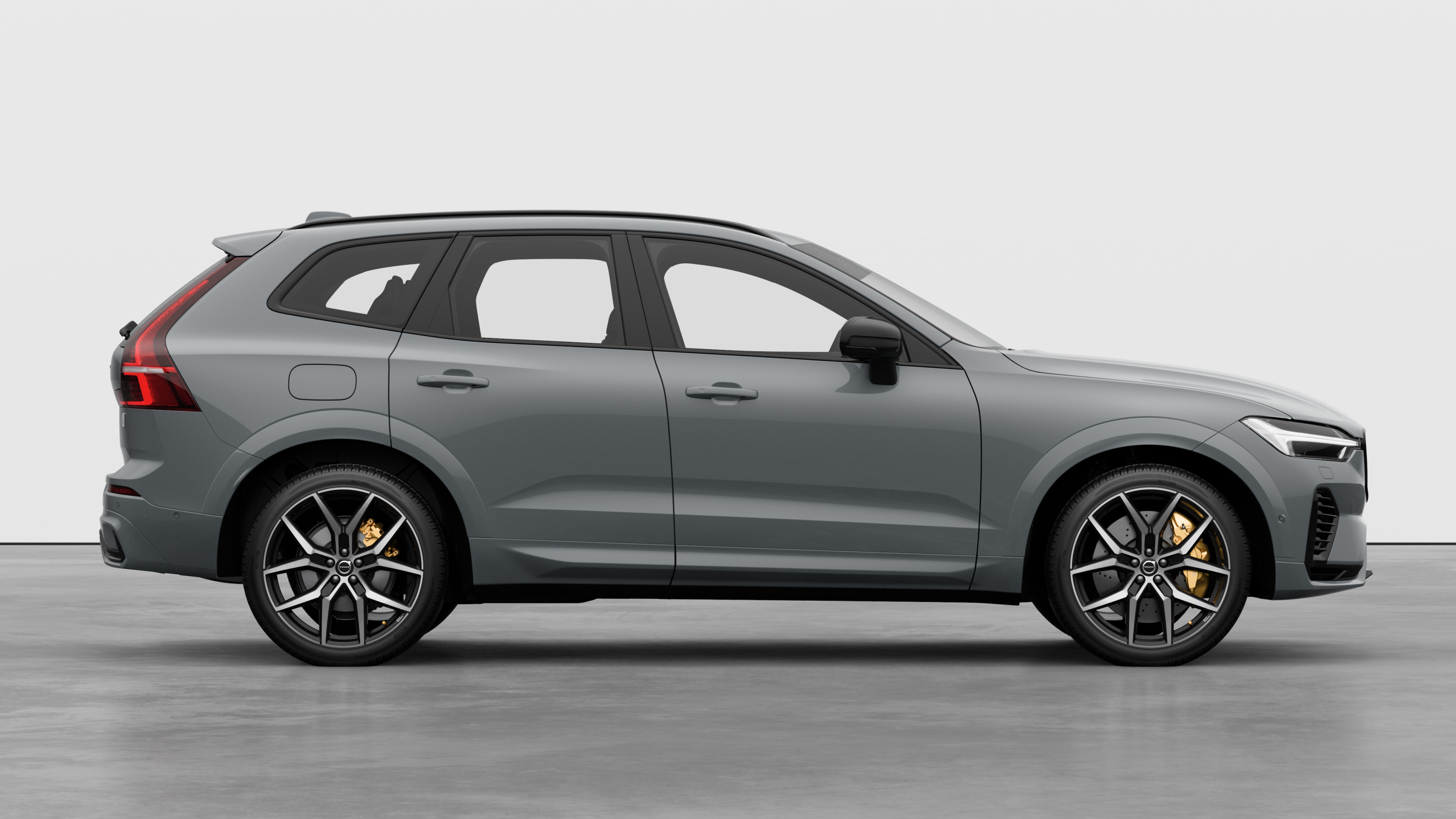 Volvo car side view on plain studio background displaying closed doors and visible wheel design.