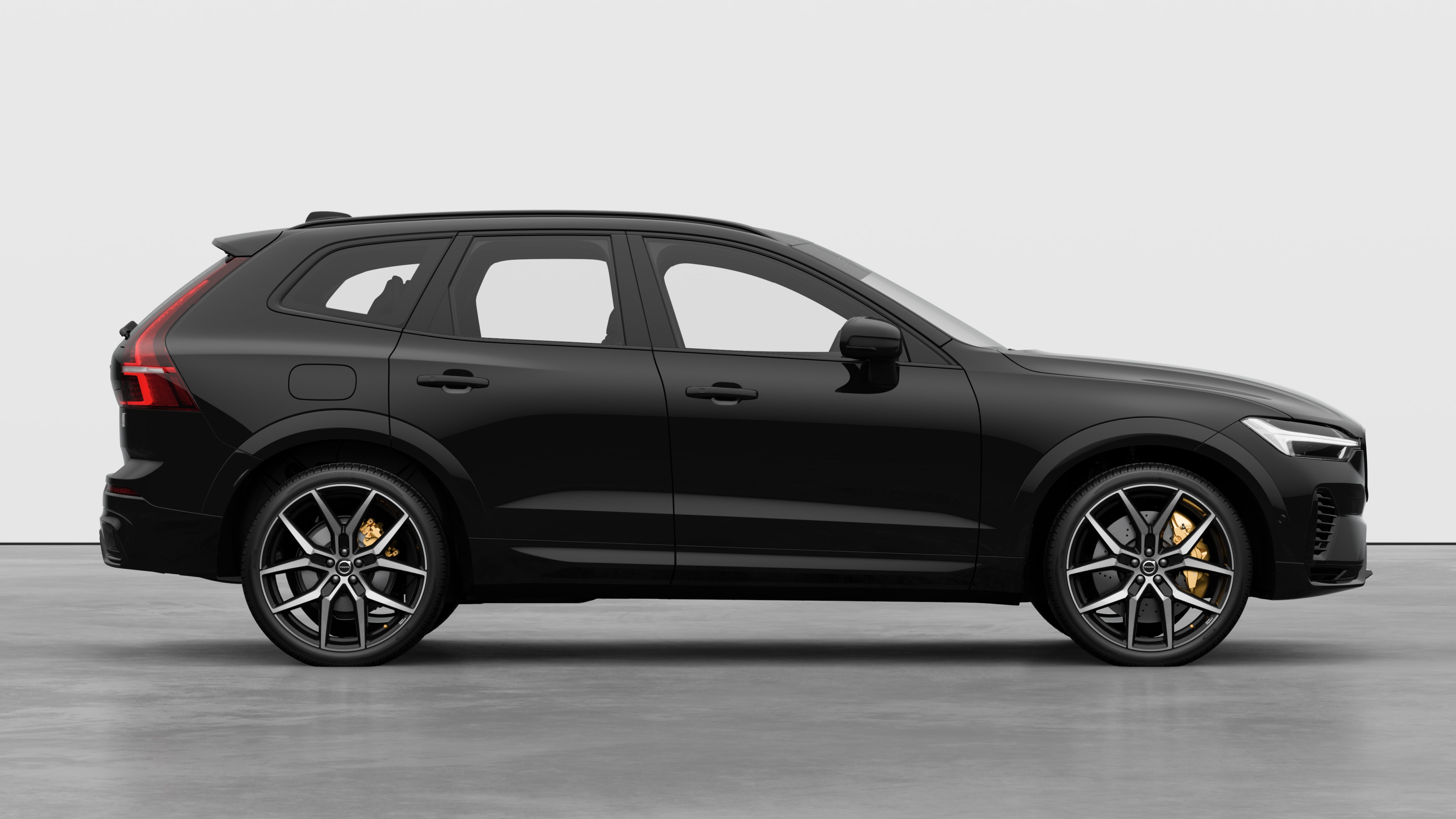 Volvo car side view on plain studio background displaying closed doors and visible wheel design.