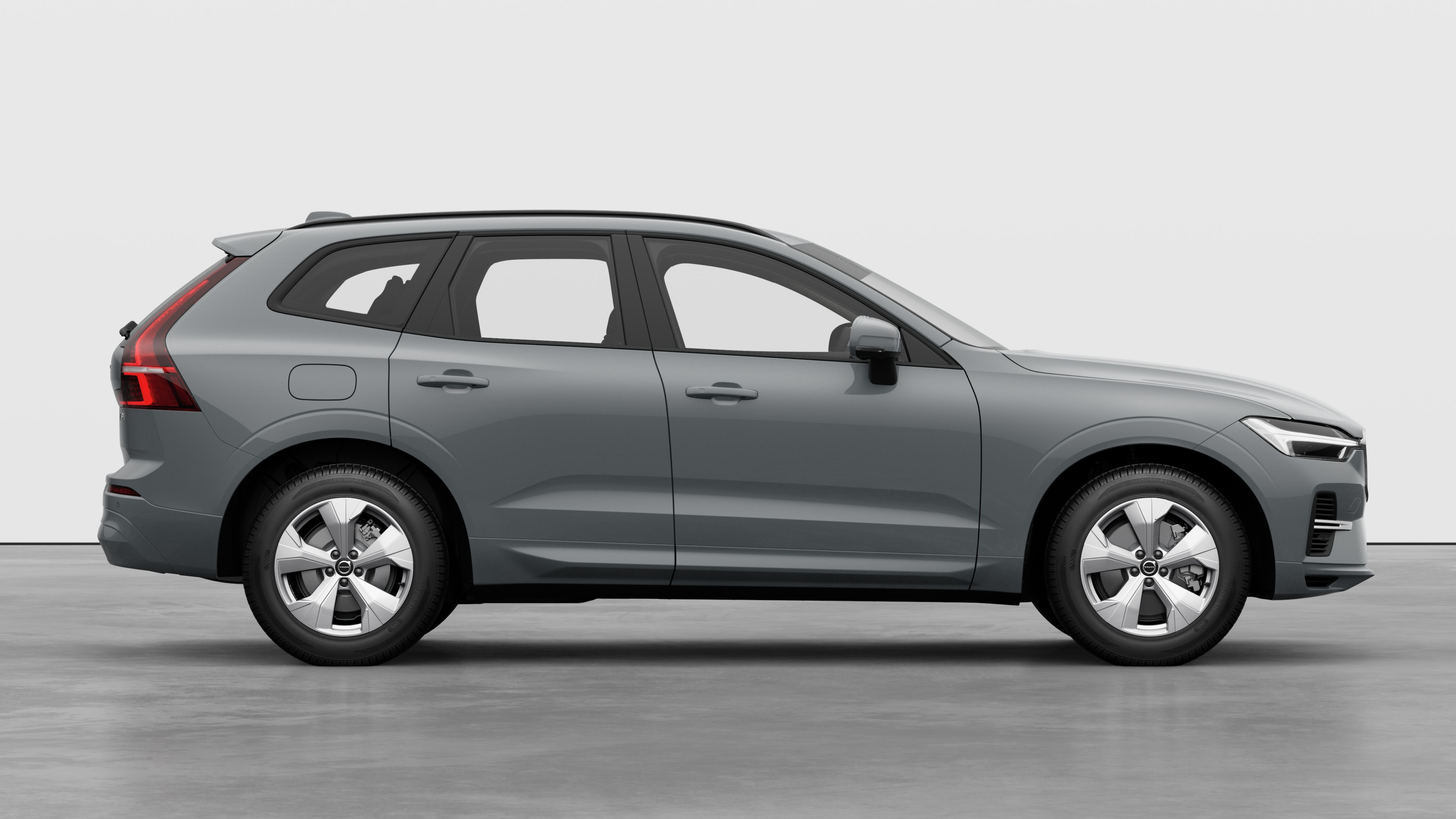 Volvo car side view on plain studio background displaying closed doors and visible wheel design.