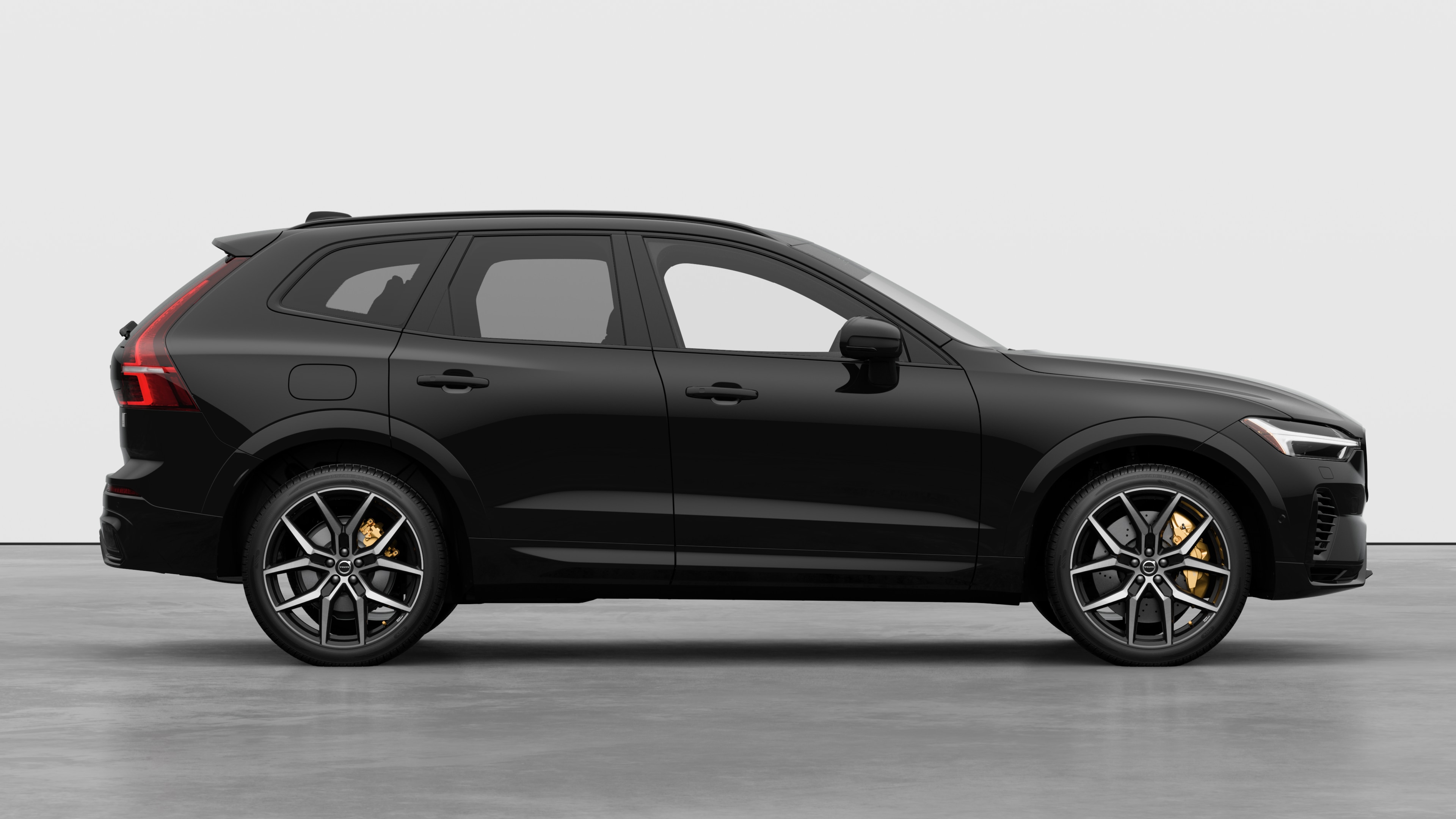 Volvo car side view on plain studio background displaying closed doors and visible wheel design.