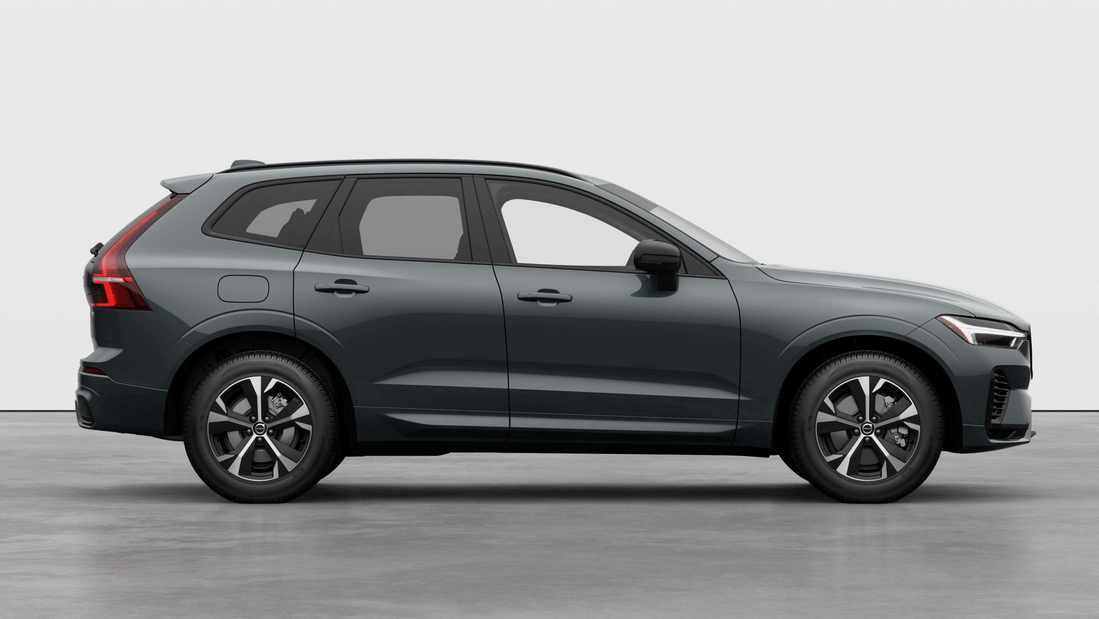 Volvo car side view on plain studio background displaying closed doors and visible wheel design.