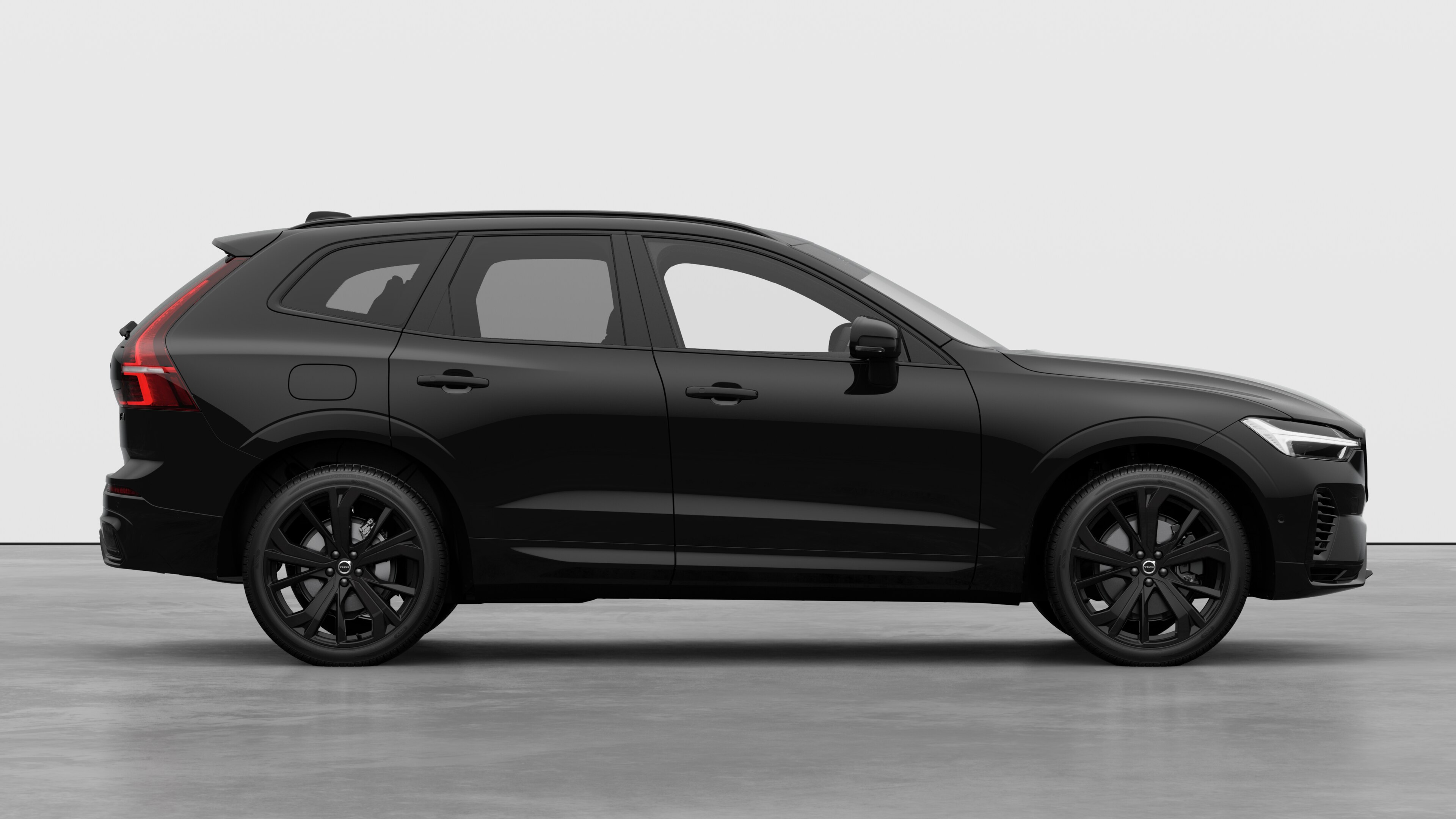 Volvo car side view on plain studio background displaying closed doors and visible wheel design.