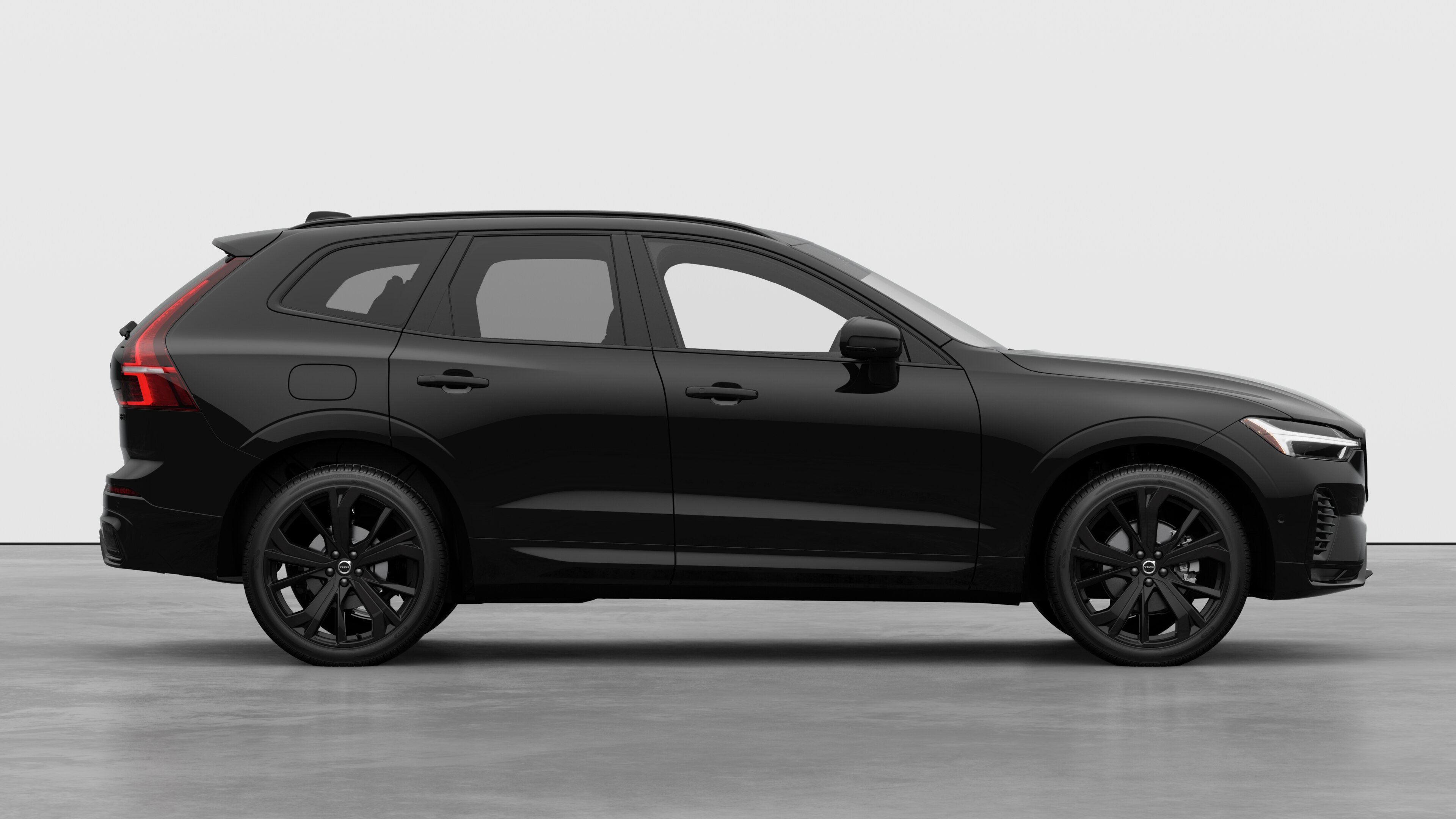 Volvo car side view on plain studio background displaying closed doors and visible wheel design.