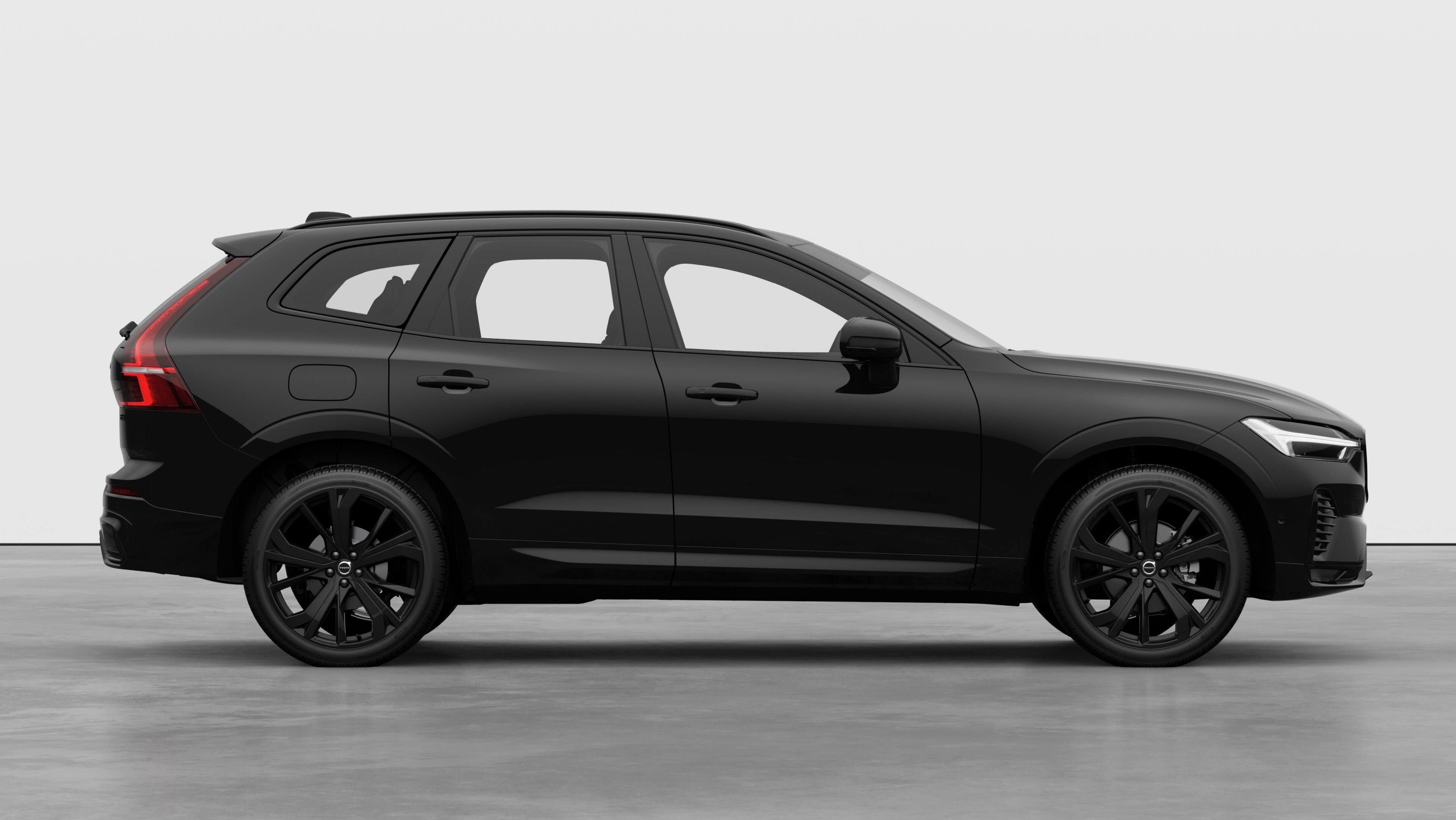 Volvo car side view on plain studio background displaying closed doors and visible wheel design.