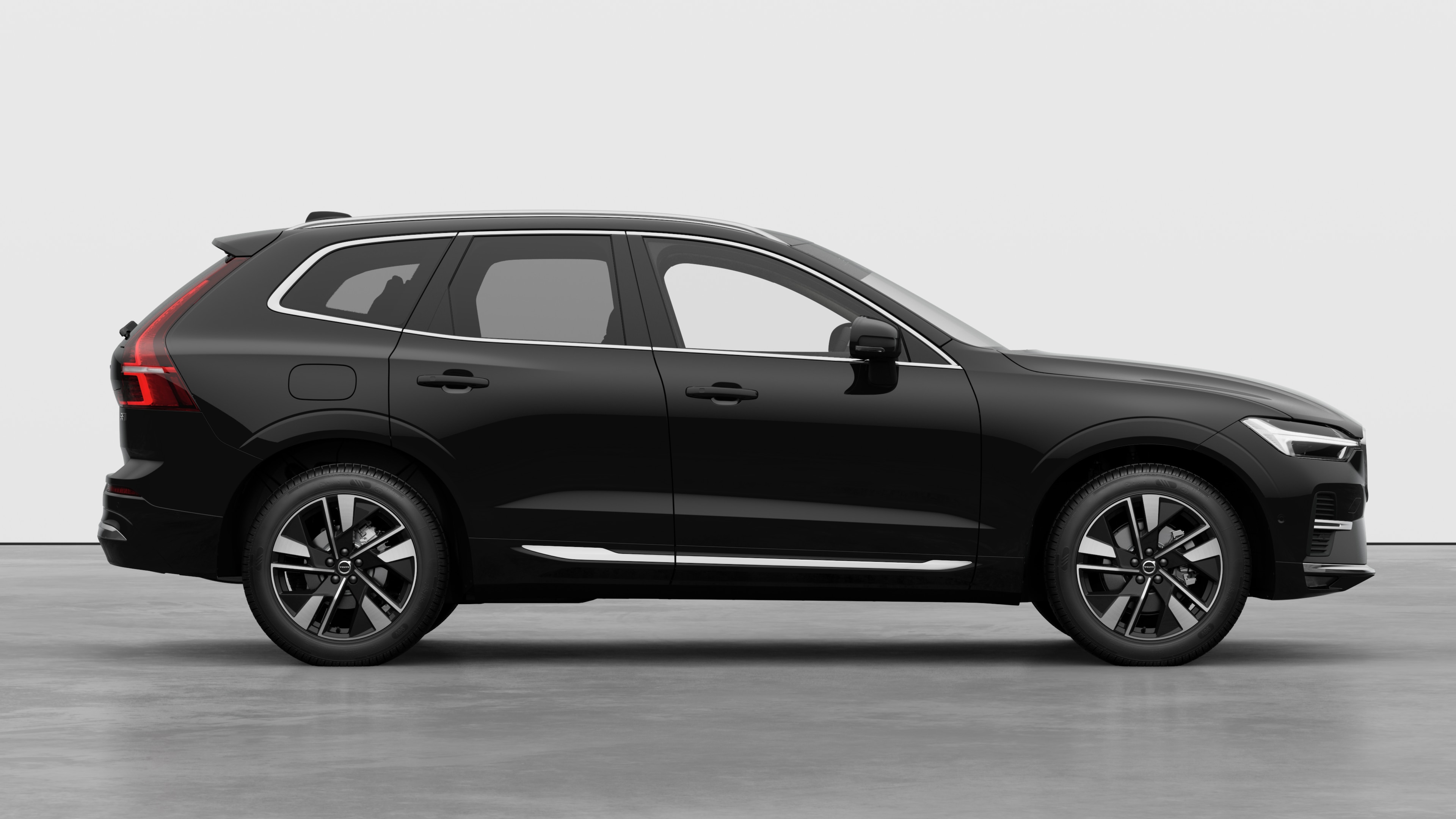 Volvo car side view on plain studio background displaying closed doors and visible wheel design.