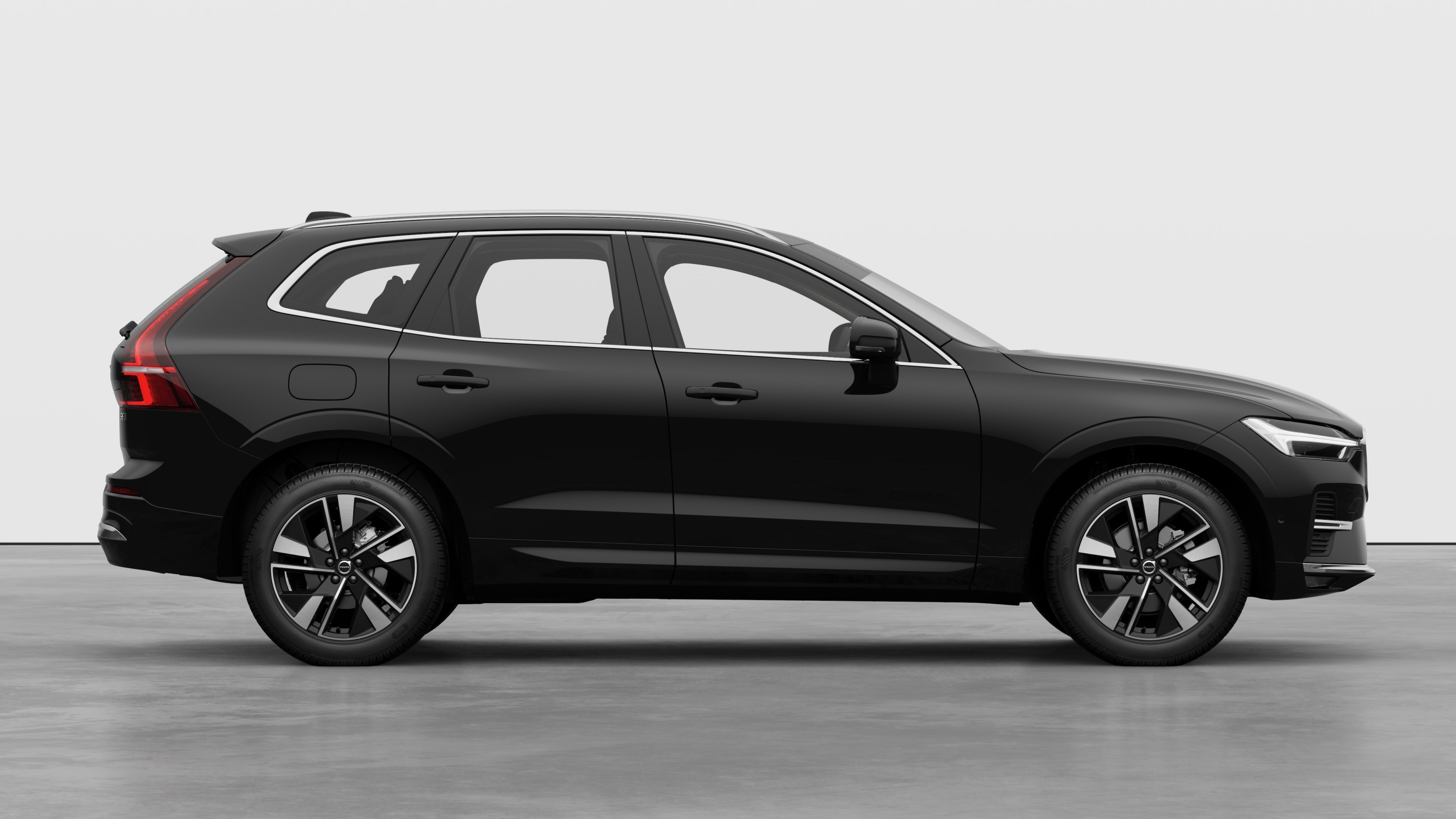 Volvo car side view on plain studio background displaying closed doors and visible wheel design.