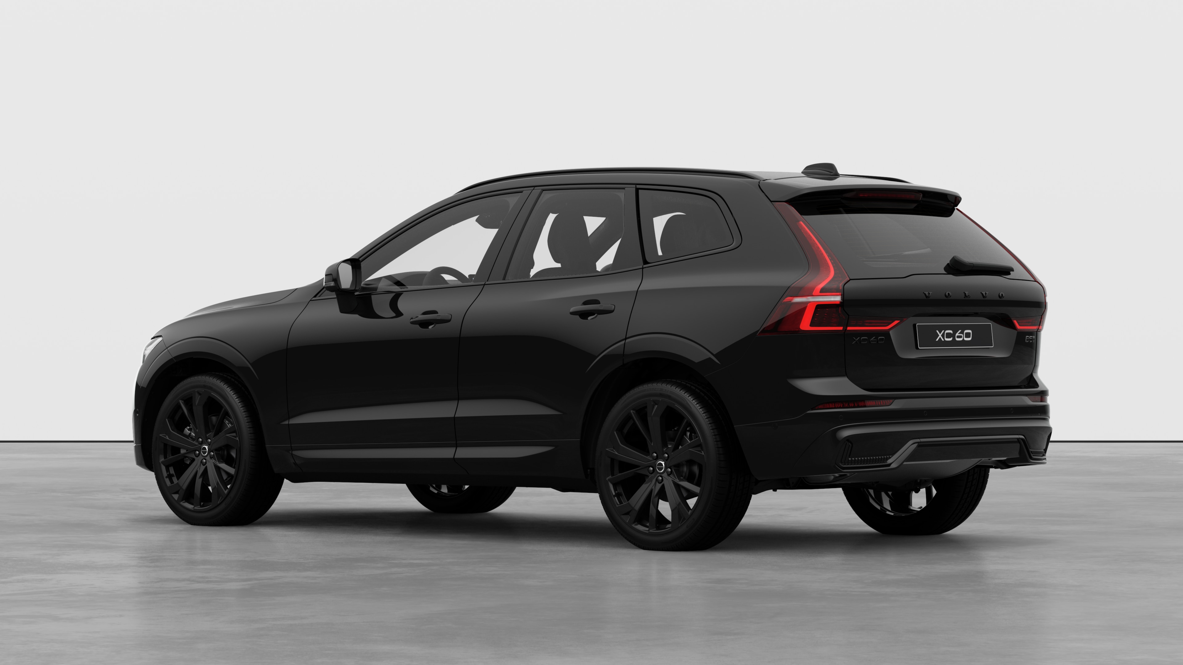Volvo car rear three-quarter view in a plain studio background.