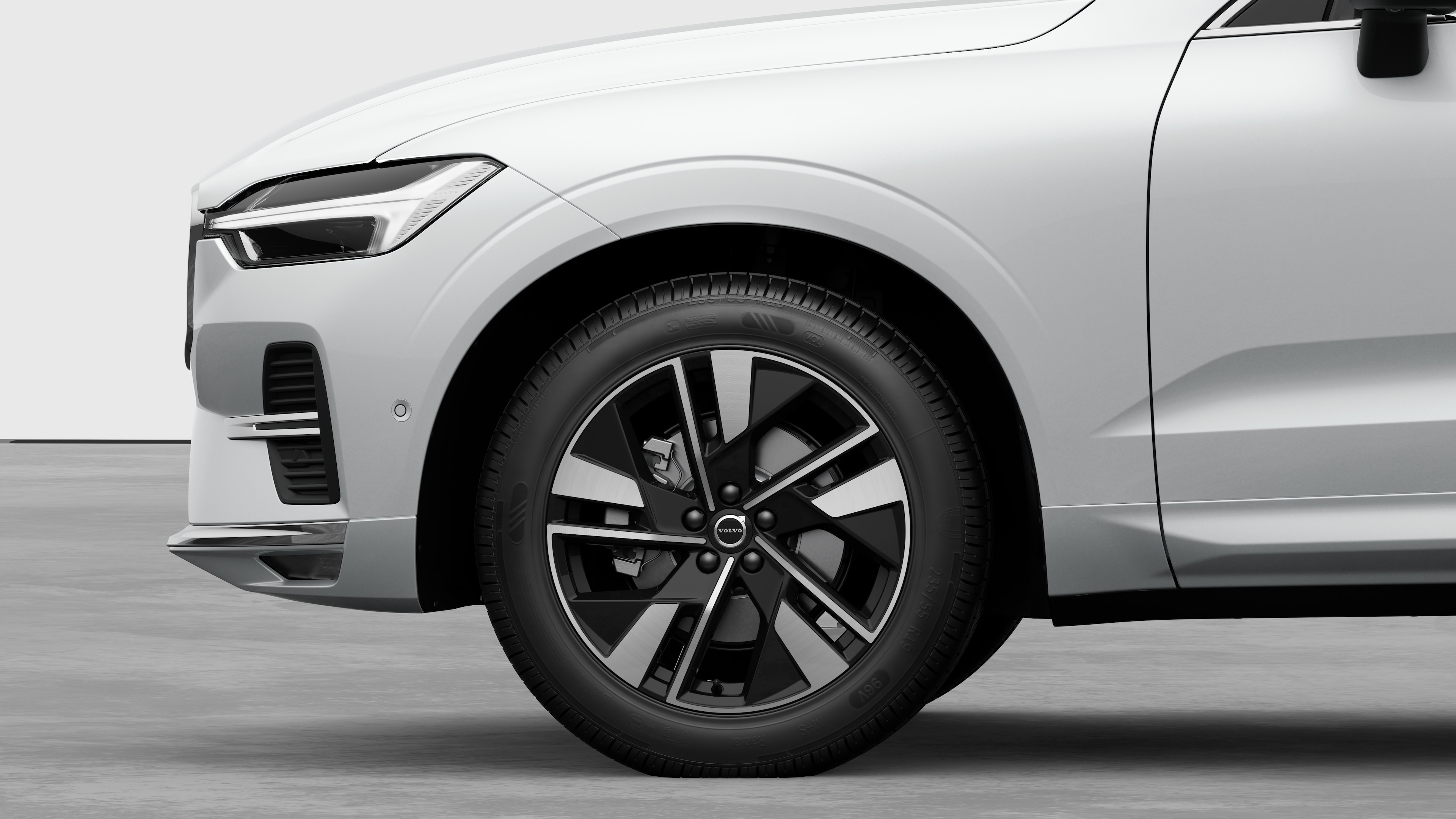 평범한 스튜디오 배경을 배경으로 앞바퀴와 펜더에 초점을 맞춘 볼보 자동차 외부 측면도.