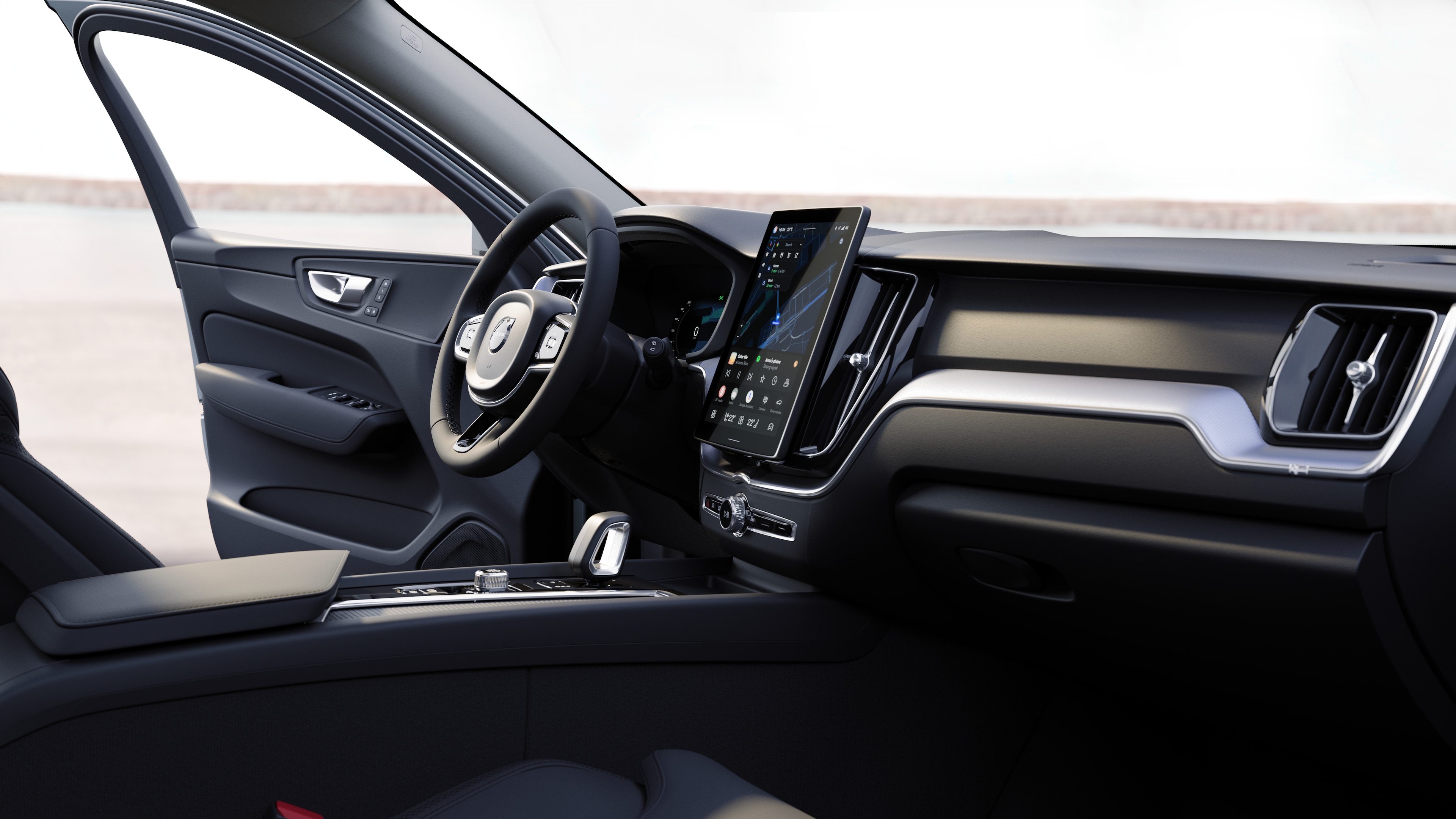 תא הנוסעים של מכונית וולוו מציג את לוח המחוונים, גלגל ההגה והקונסולה המרכזית עם תצוגה דיגיטלית על רקע כביש פתוח.