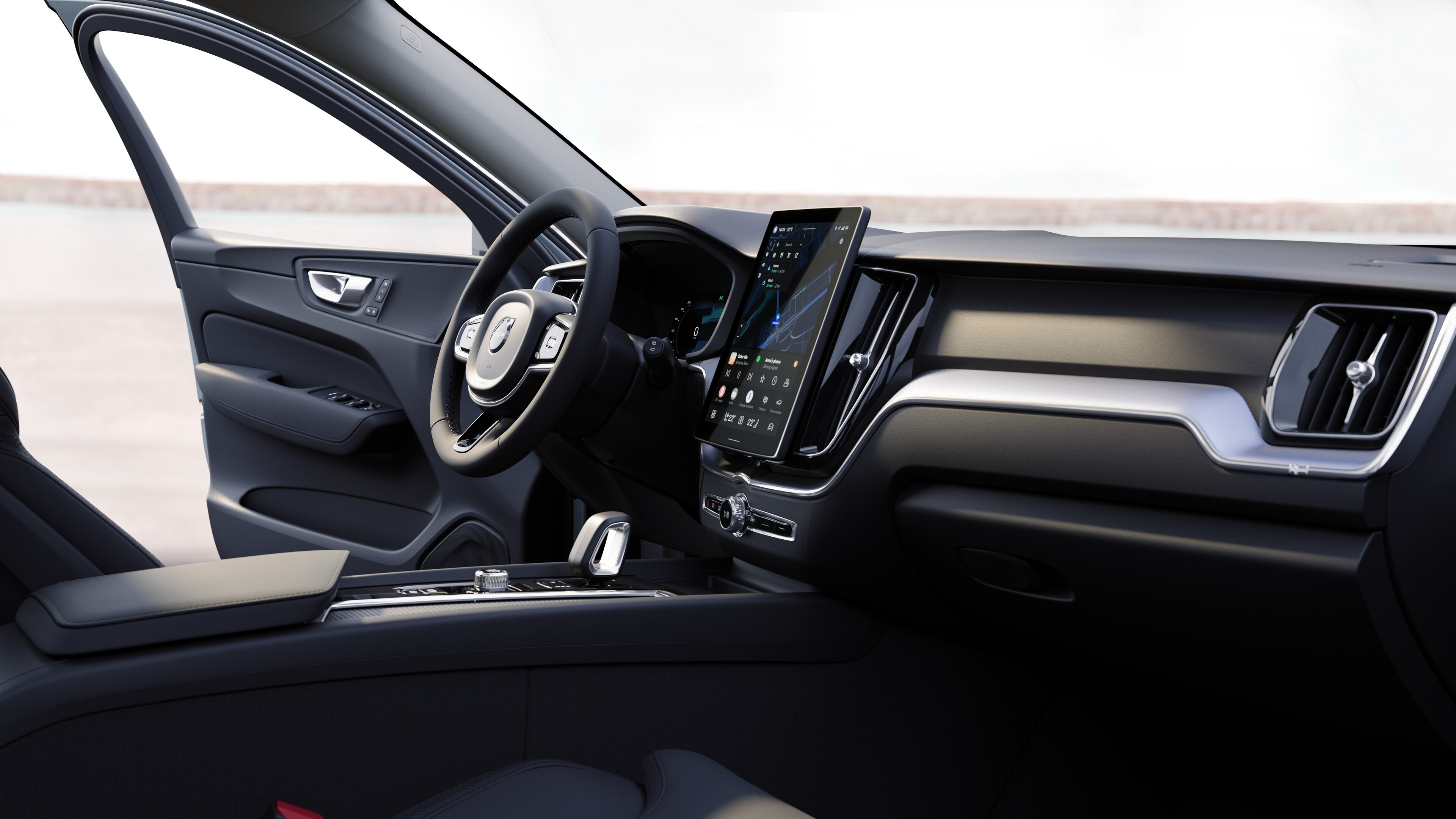 תא הנוסעים של מכונית וולוו מציג את לוח המחוונים, גלגל ההגה והקונסולה המרכזית עם תצוגה דיגיטלית על רקע כביש פתוח.