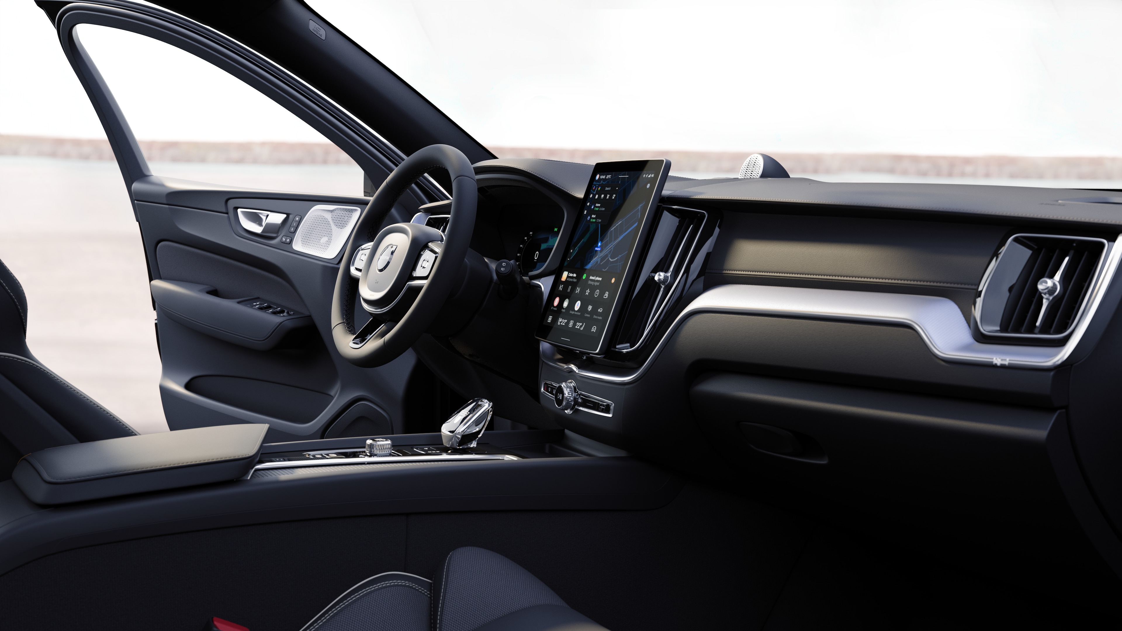 Volvo car interior showing dashboard, steering wheel, and center console with digital display in an open road background.