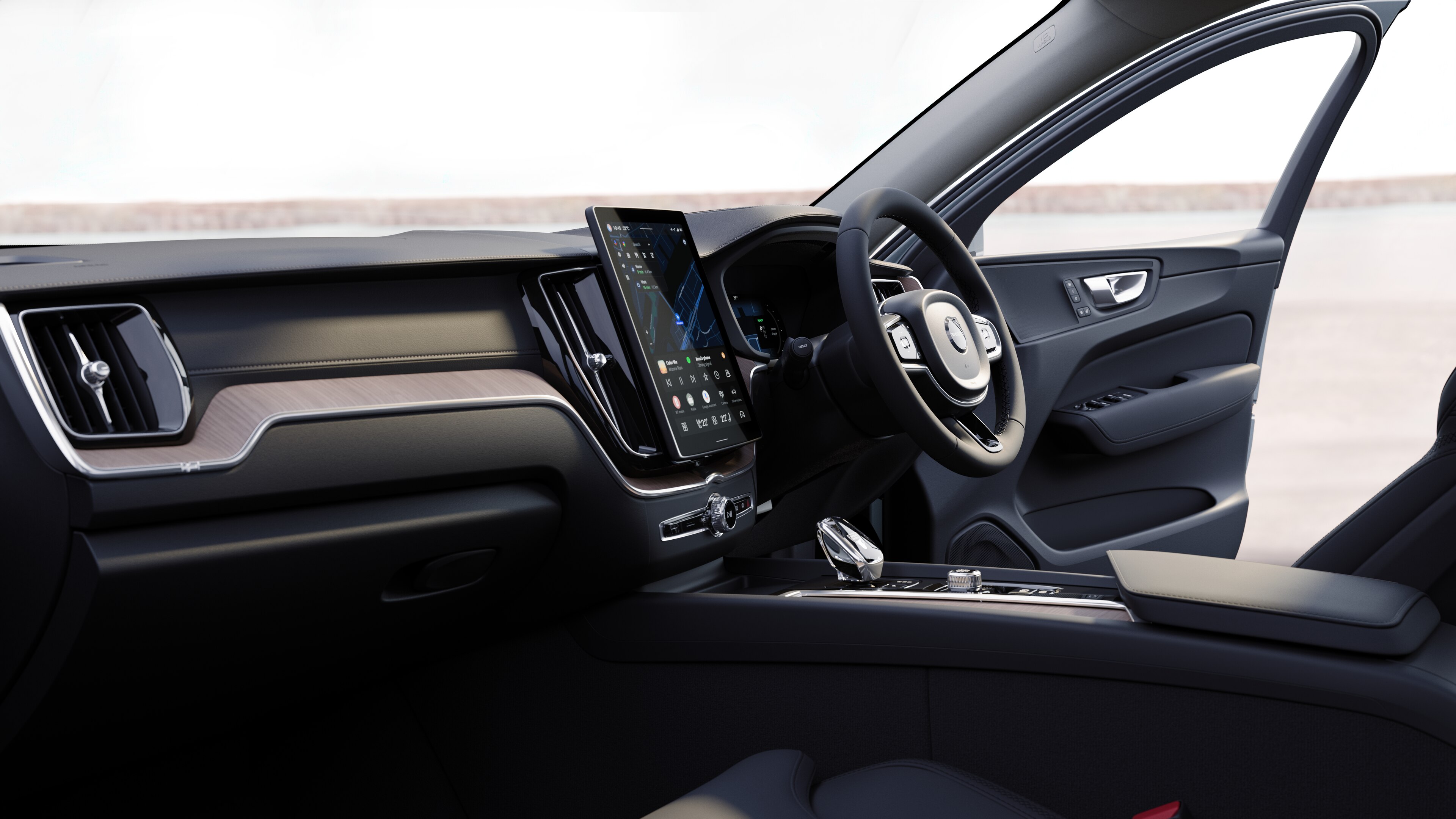 Volvo car interior showing dashboard, steering wheel, and center console with digital display in an open road background.