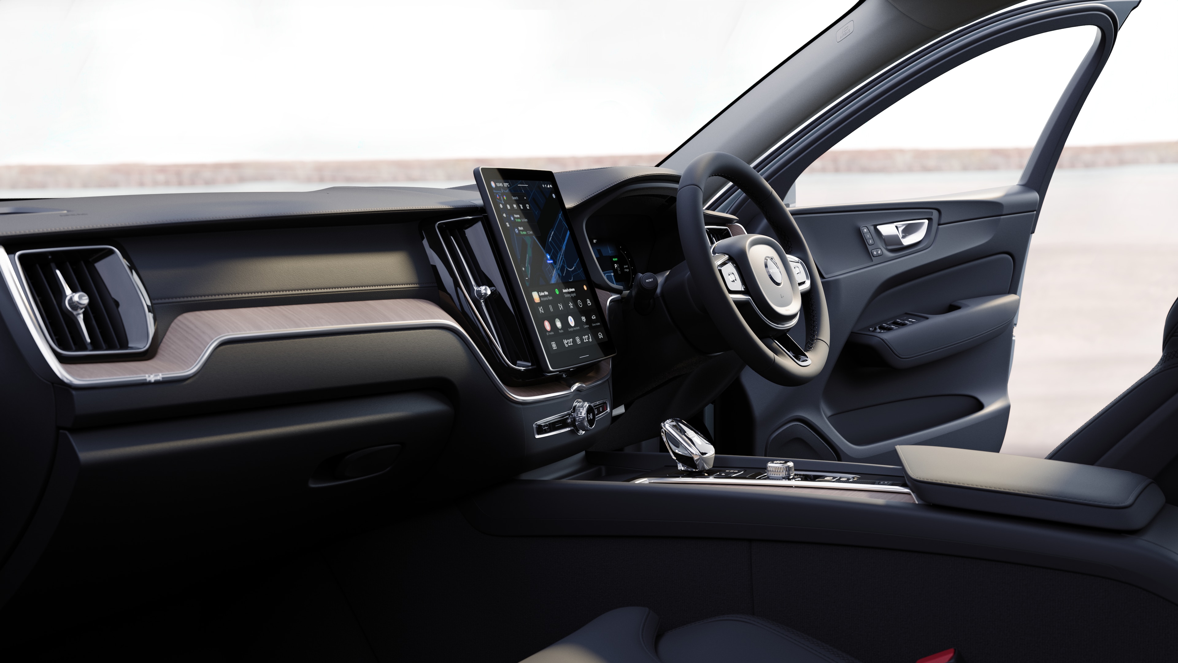 Volvo car interior showing dashboard, steering wheel, and center console with digital display in an open road background.