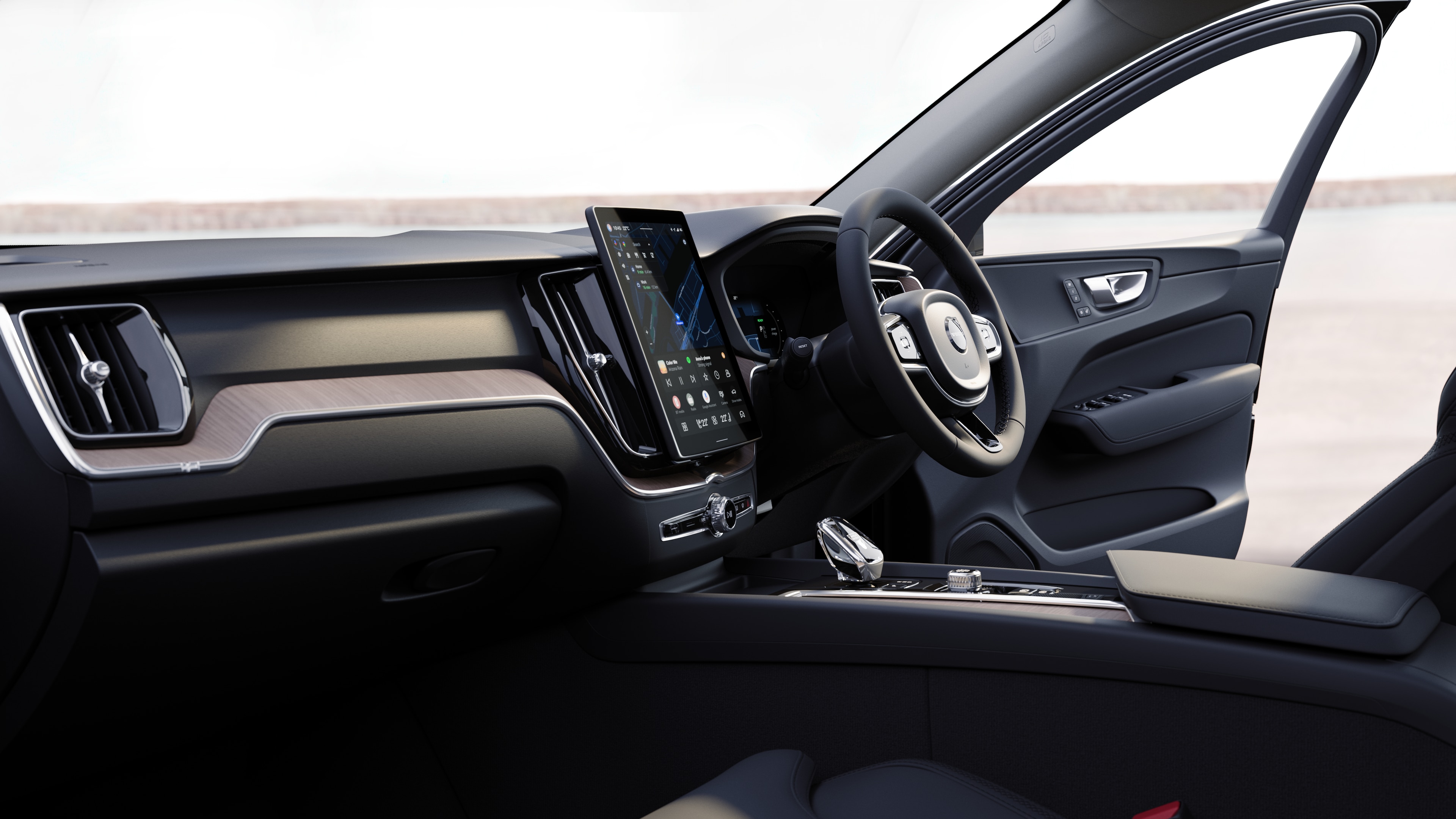 Volvo car interior showing dashboard, steering wheel, and center console with digital display in an open road background.
