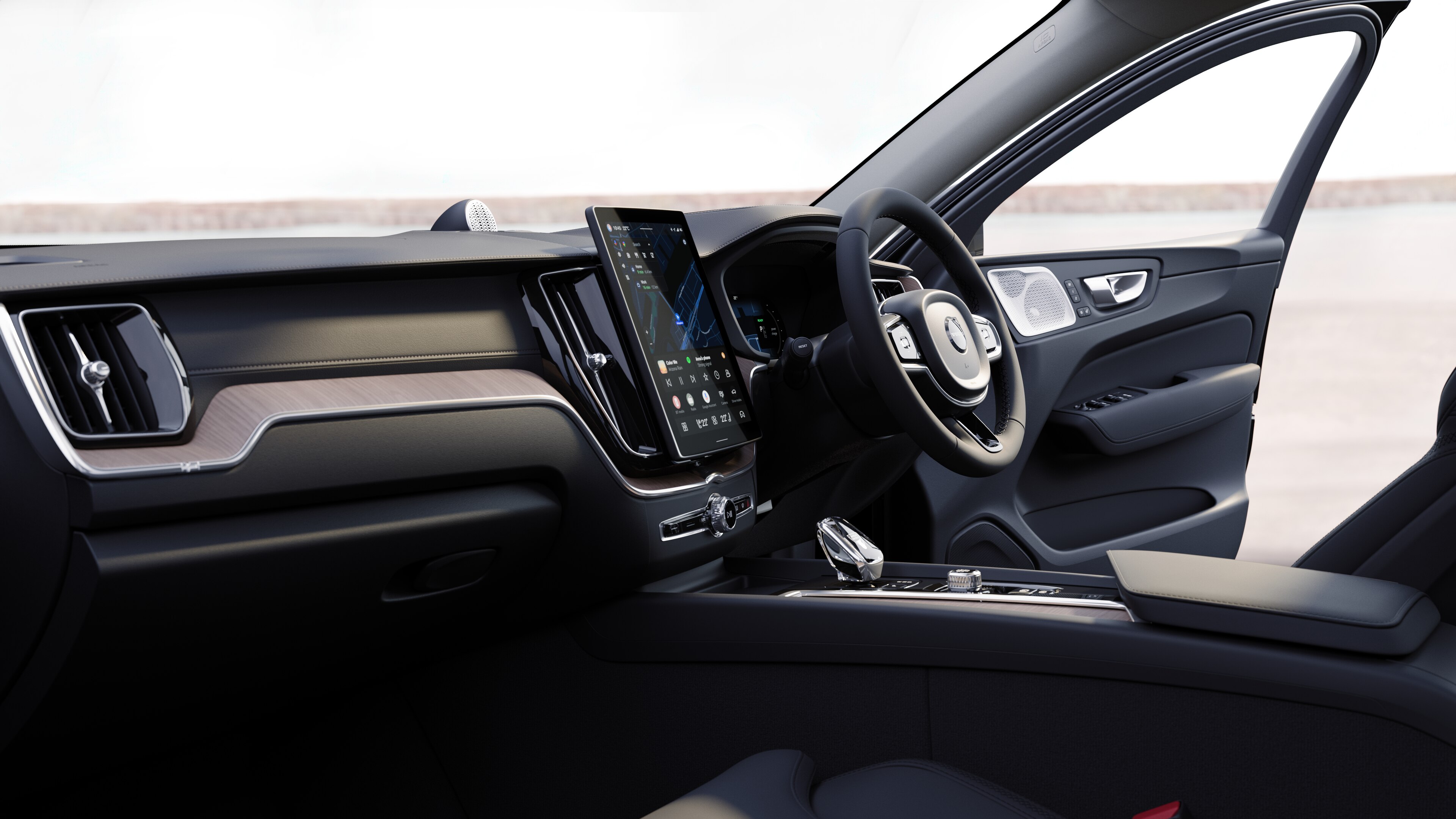 Volvo car interior showing dashboard, steering wheel, and center console with digital display in an open road background.