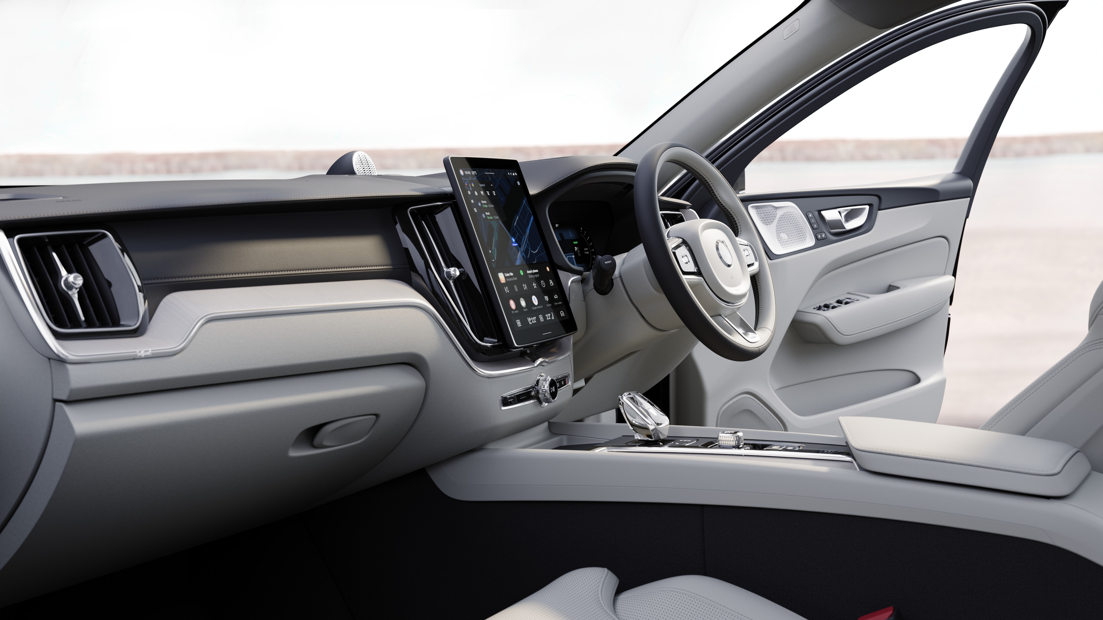 Volvo car interior showing dashboard, steering wheel, and center console with digital display in an open road background.