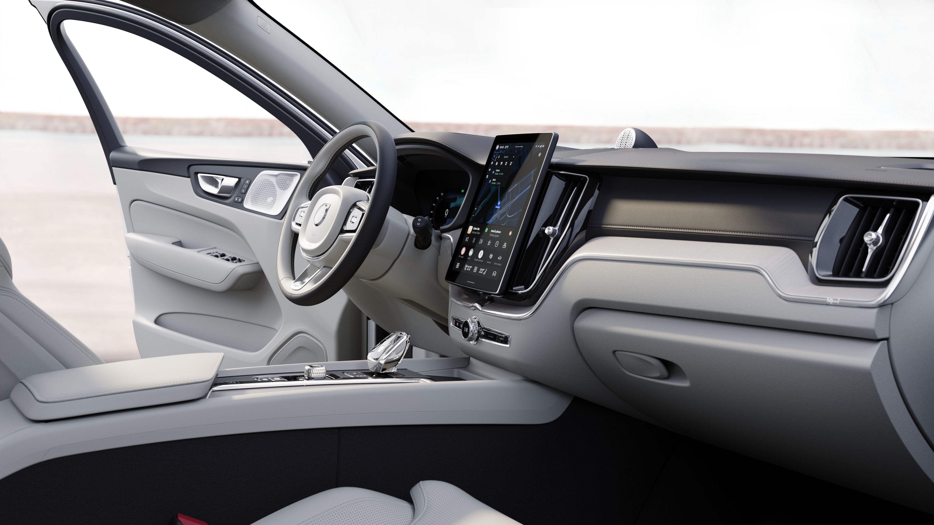 열린 도로 배경에 디지털 디스플레이가 있는 대시보드, 스티어링 휠 및 센터 콘솔을 보여주는 볼보 자동차 내부.