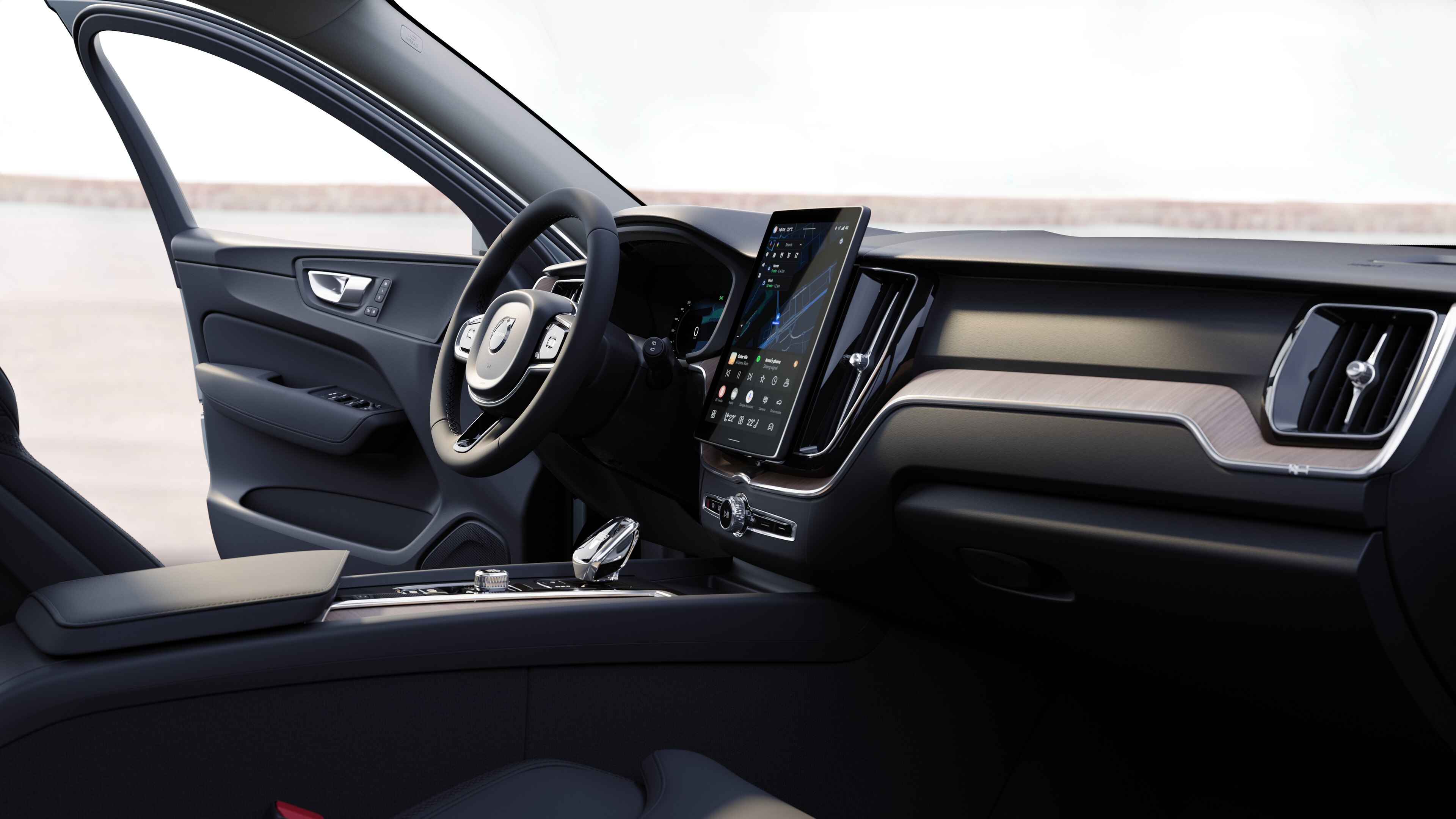 Volvointeriör som visar instrumentbräda, ratt och mittkonsol med digital display i en öppen bakgrund.