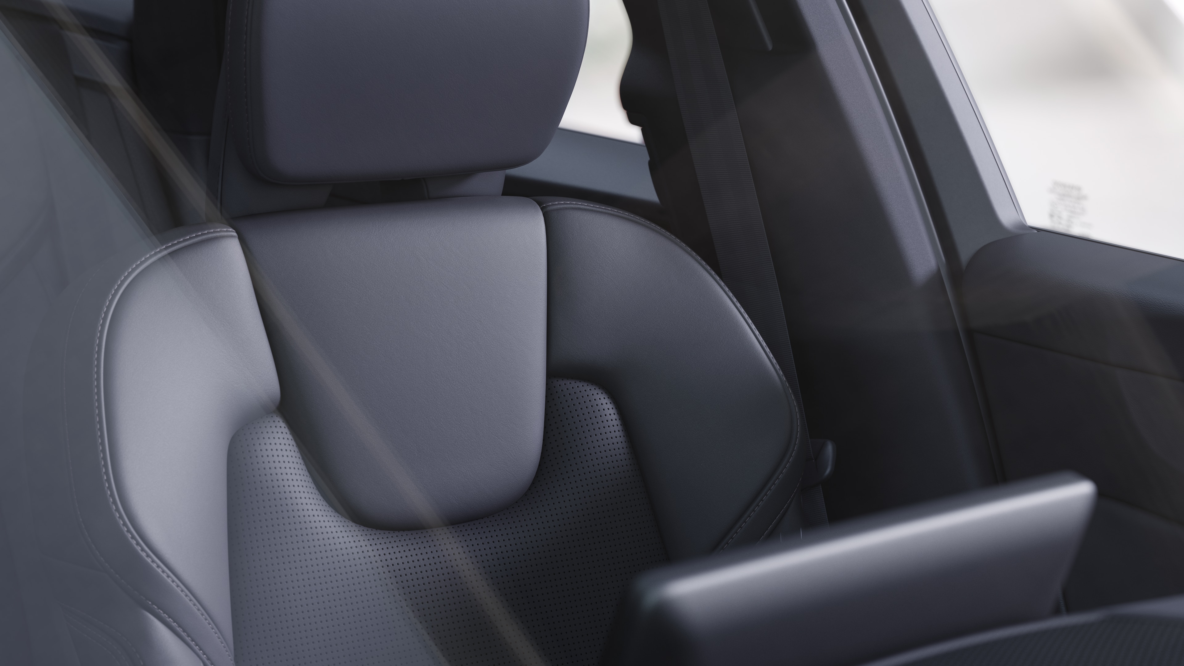 Volvo car interior showing front and rear passenger seats, steering wheel, dashboard, and center console against a plain studio background.