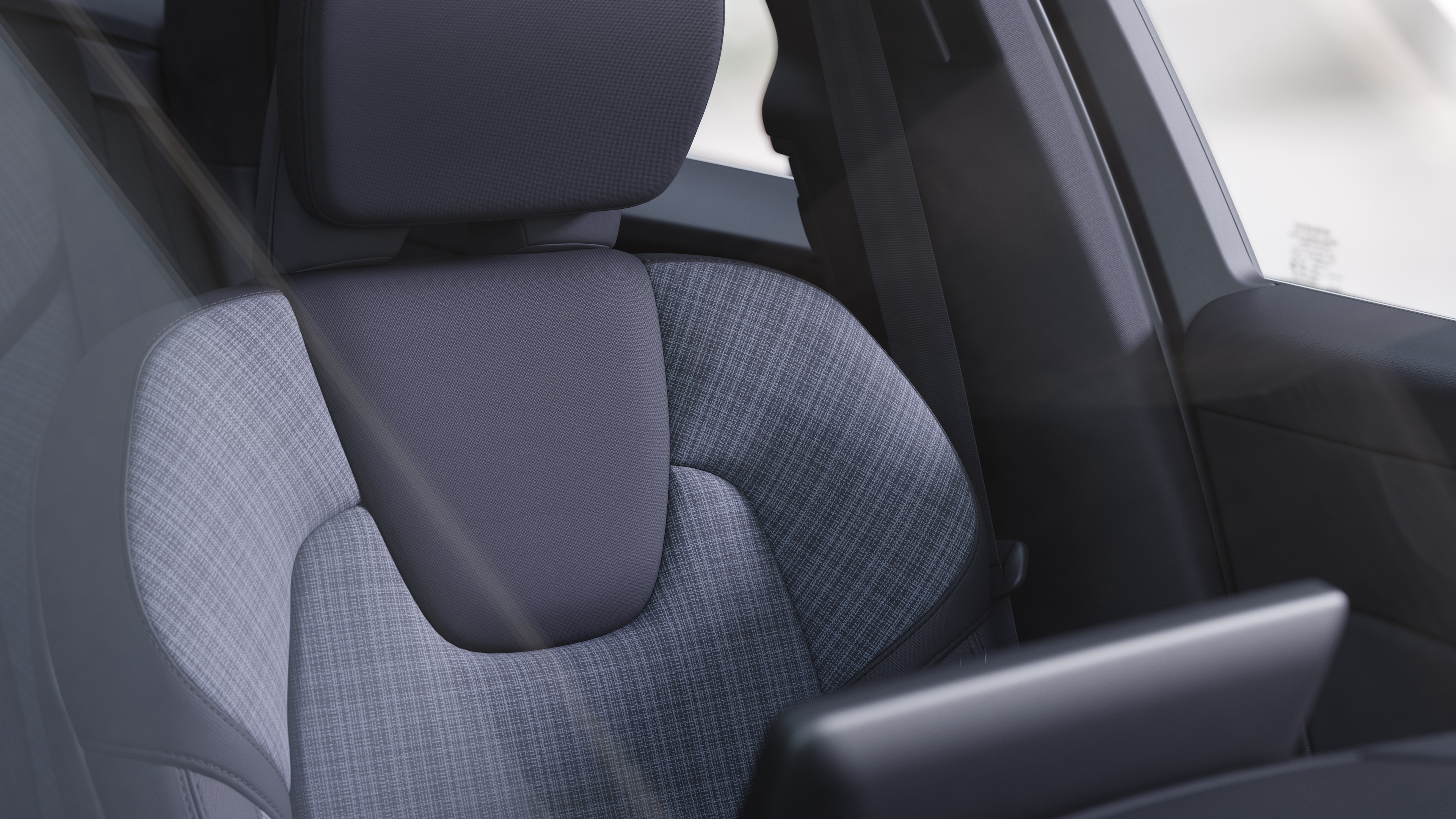 Volvo car interior showing front and rear passenger seats, steering wheel, dashboard, and center console against a plain studio background.