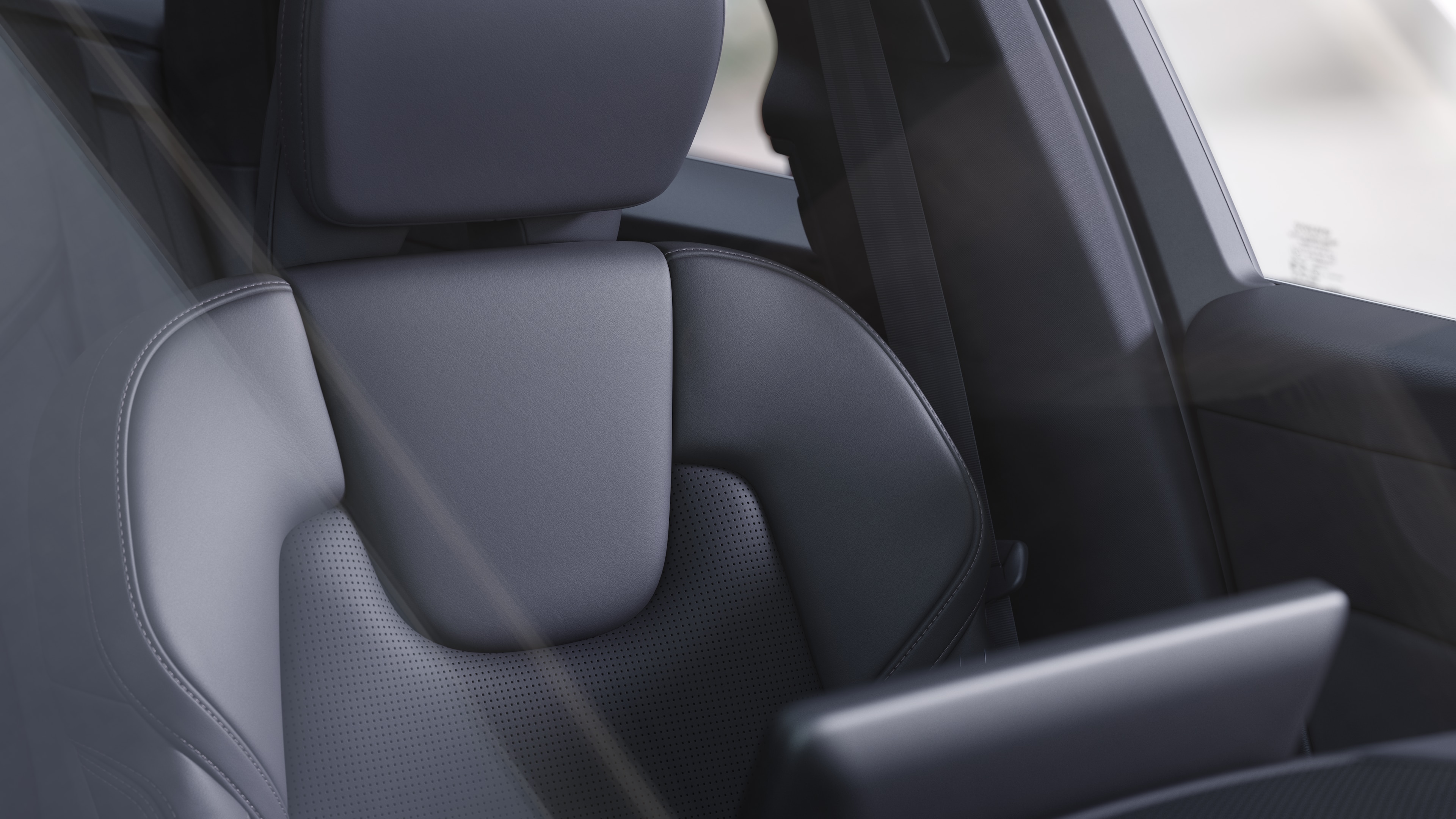 Volvo car interior showing front and rear passenger seats, steering wheel, dashboard, and center console against a plain studio background.