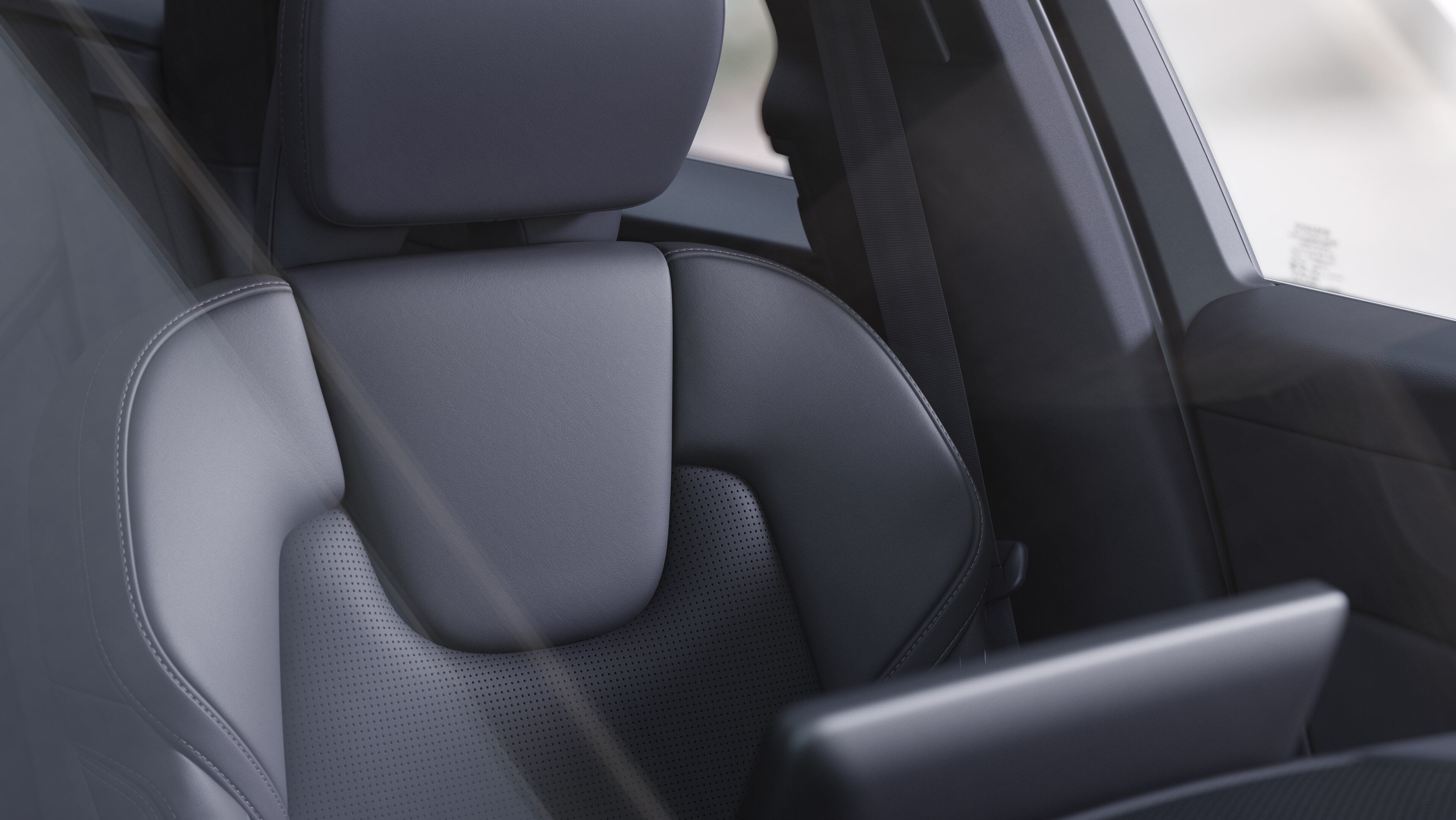 Volvo car interior showing front and rear passenger seats, steering wheel, dashboard, and center console against a plain studio background.