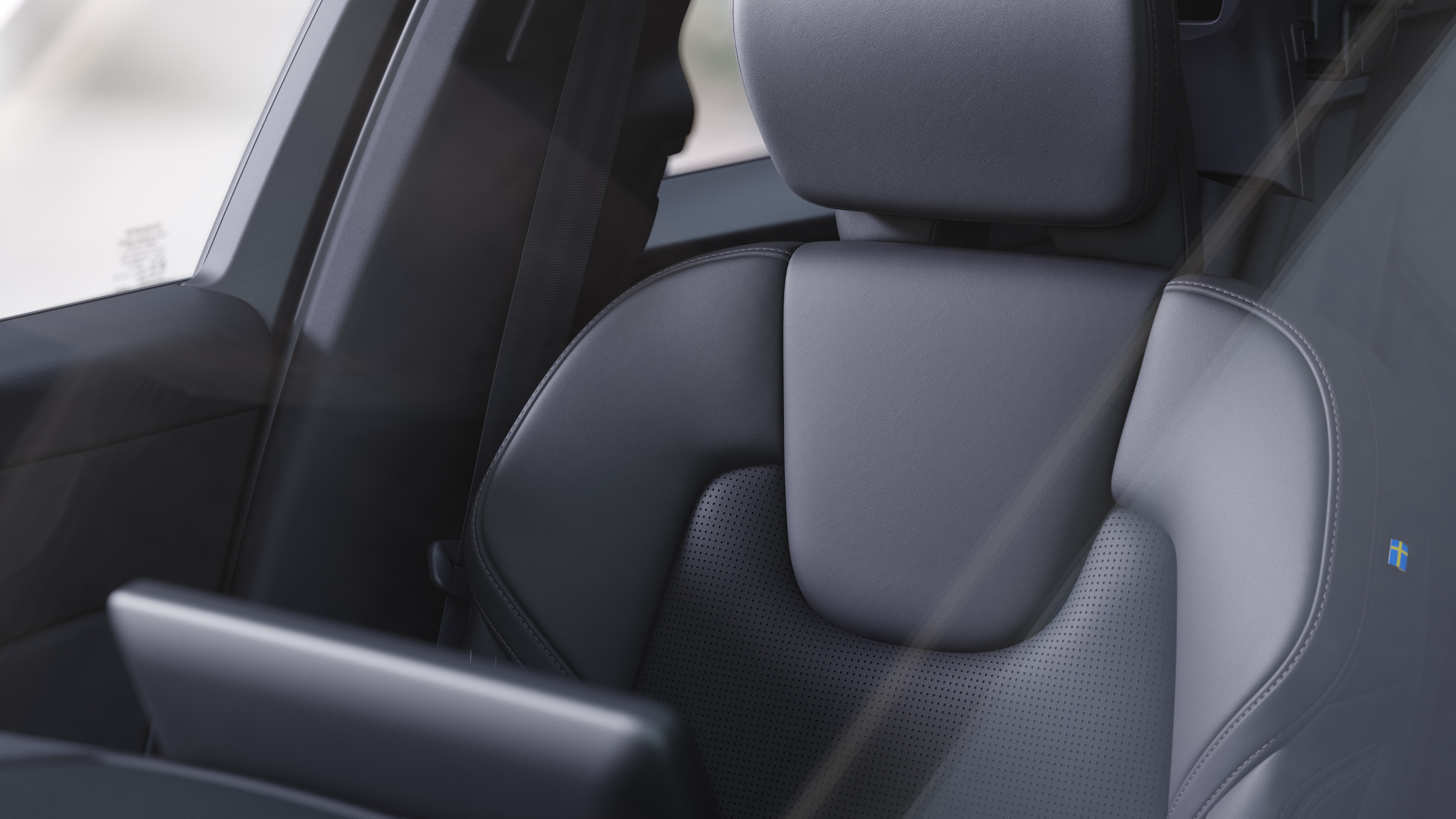 Volvo car interior showing front and rear passenger seats, steering wheel, dashboard, and center console against a plain studio background.