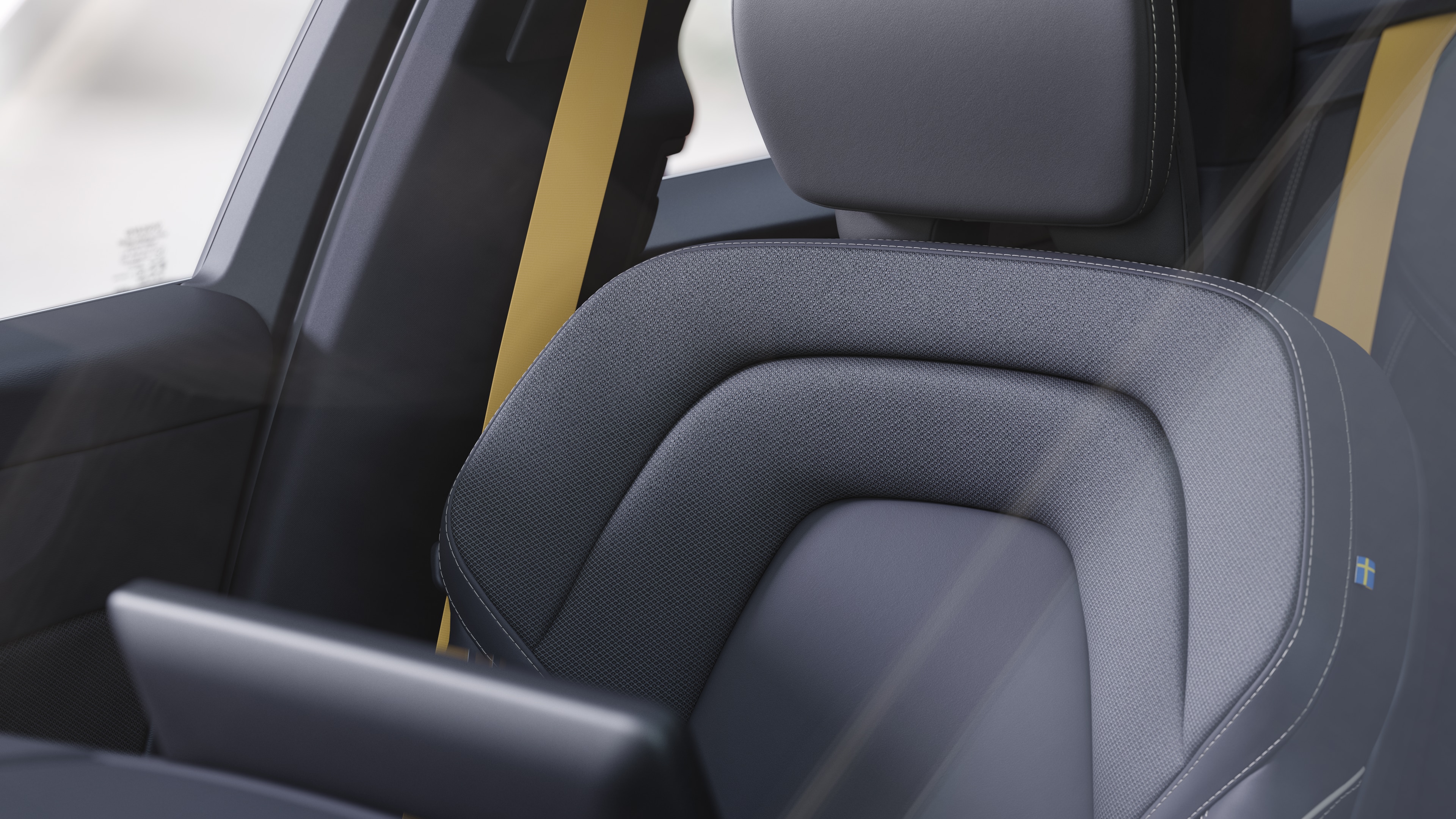 Volvo car interior showing front and rear passenger seats, steering wheel, dashboard, and center console against a plain studio background.