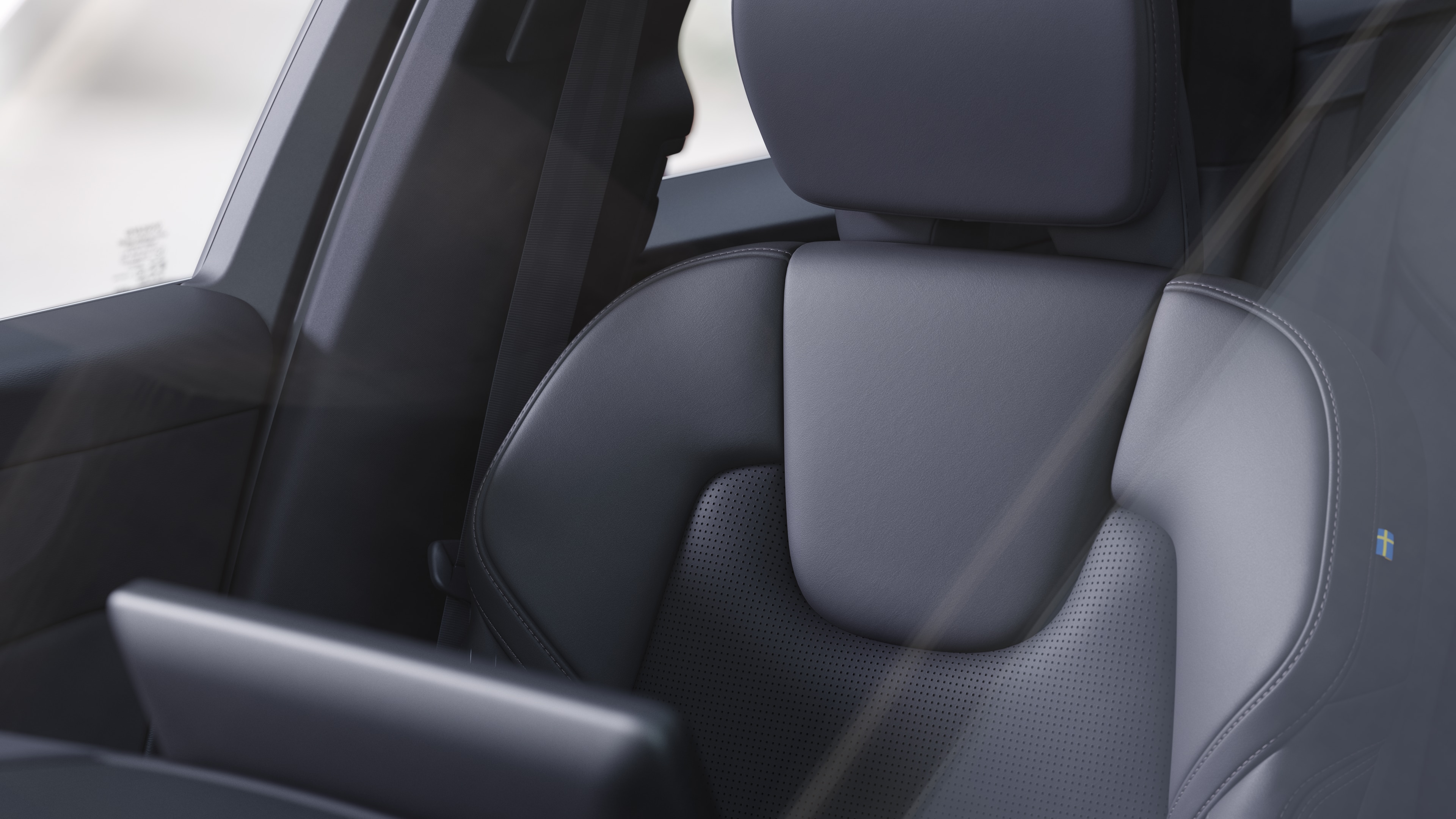 Volvo car interior showing front and rear passenger seats, steering wheel, dashboard, and center console against a plain studio background.