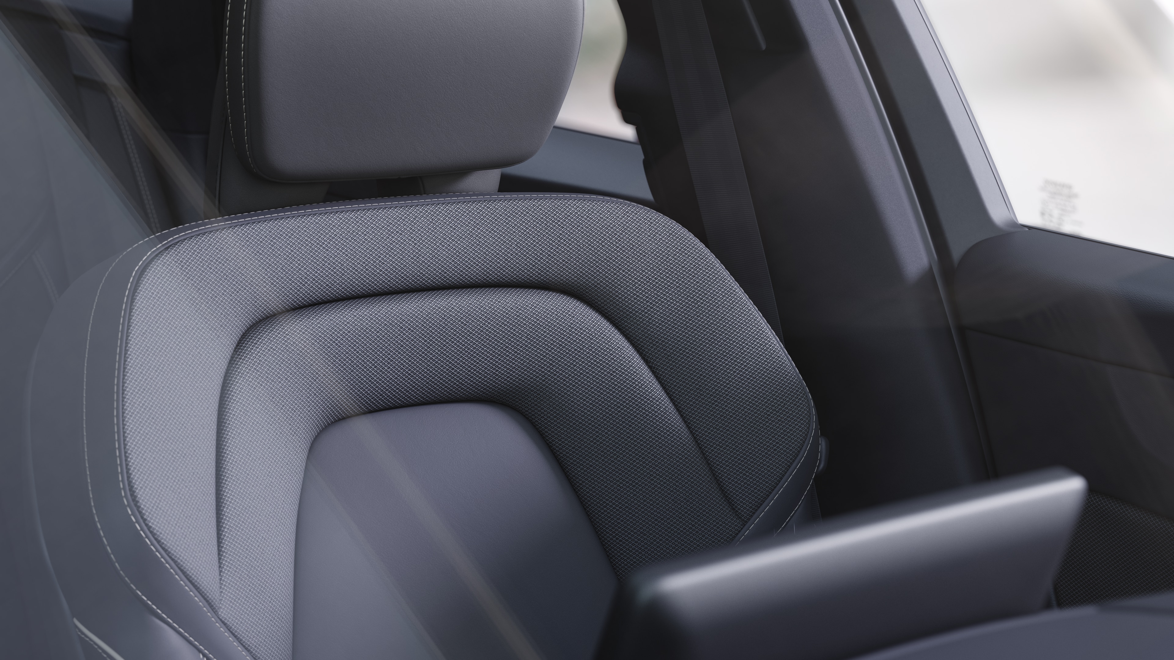 Volvo car interior showing front and rear passenger seats, steering wheel, dashboard, and center console against a plain studio background.