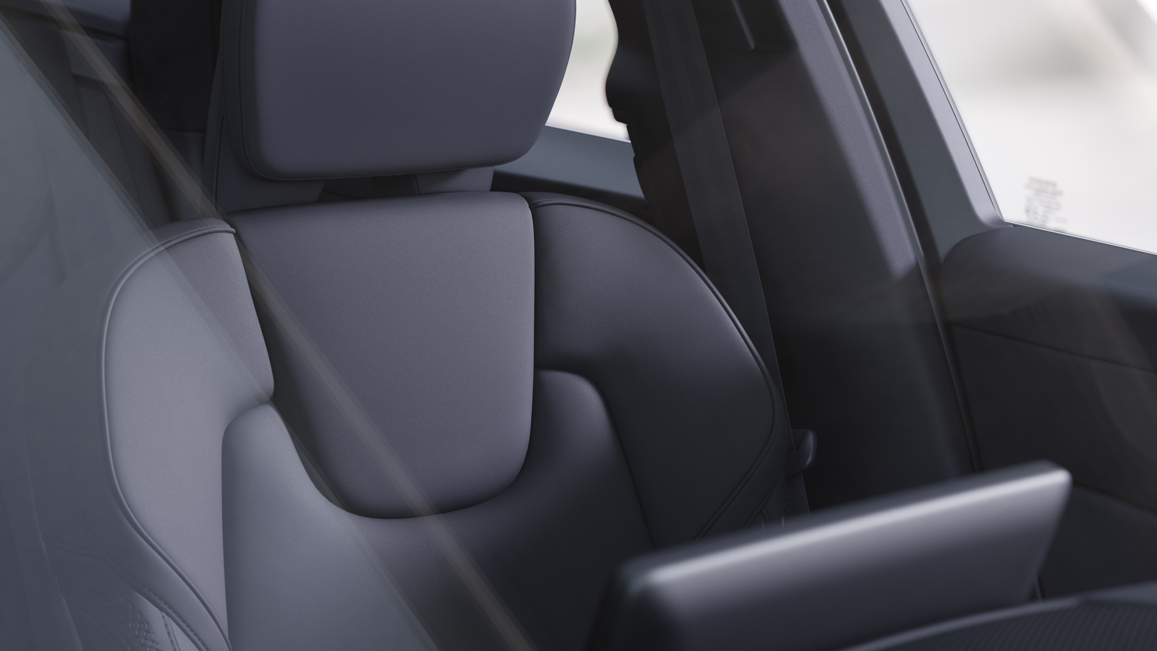 Volvo car interior showing front and rear passenger seats, steering wheel, dashboard, and center console against a plain studio background.