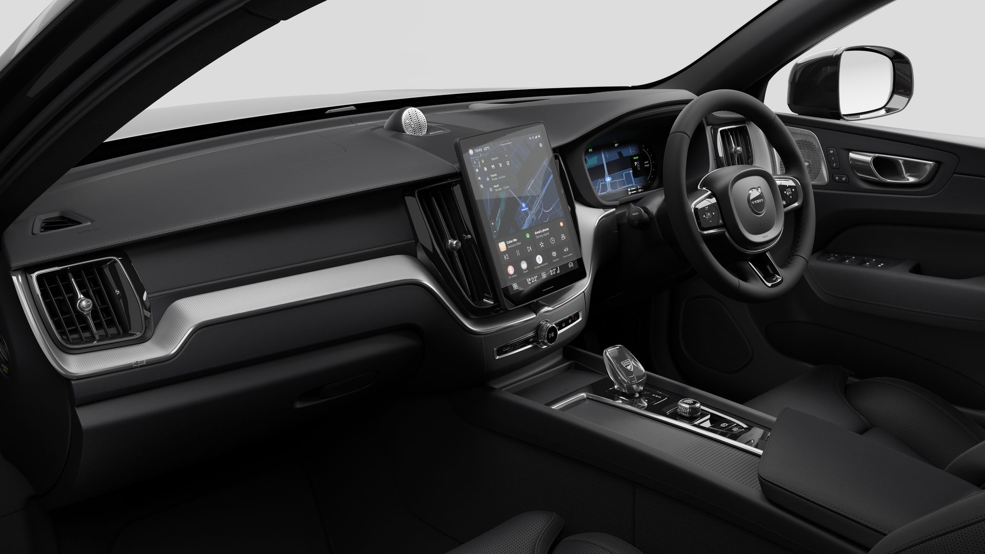 Interior view of a Volvo car showing the dashboard, steering wheel, center console, and digital display screen in a plain studio background.