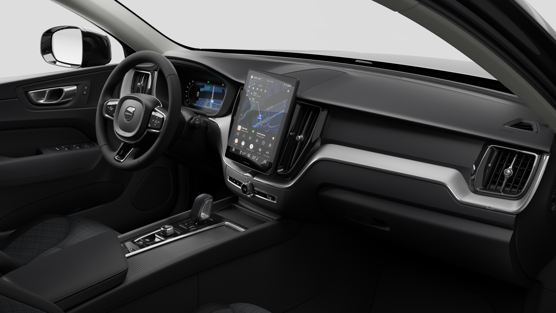 Vue intérieure d’une Volvo montrant le tableau de bord, le volant, la console centrale et l’écran d’affichage numérique sur un fond de studio uni.