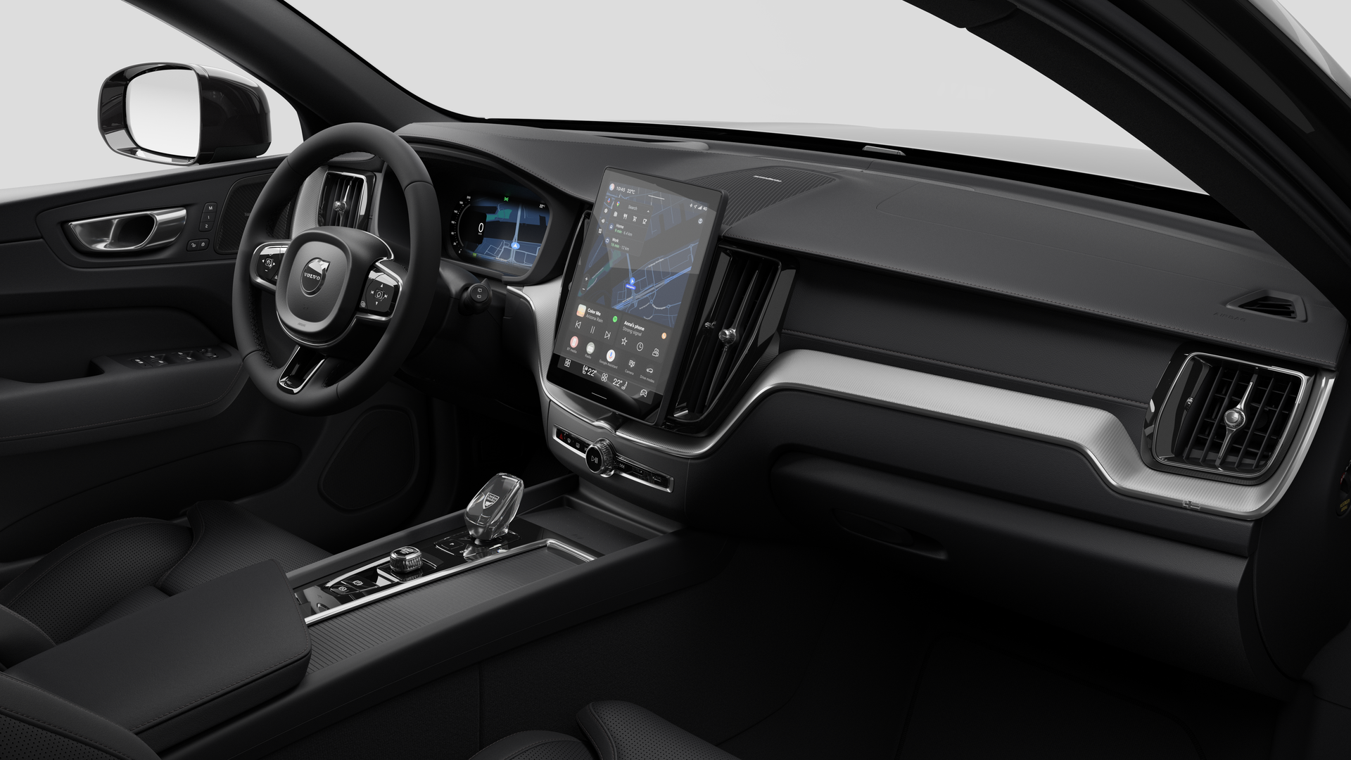 Interior view of a Volvo car showing the dashboard, steering wheel, center console, and digital display screen in a plain studio background.