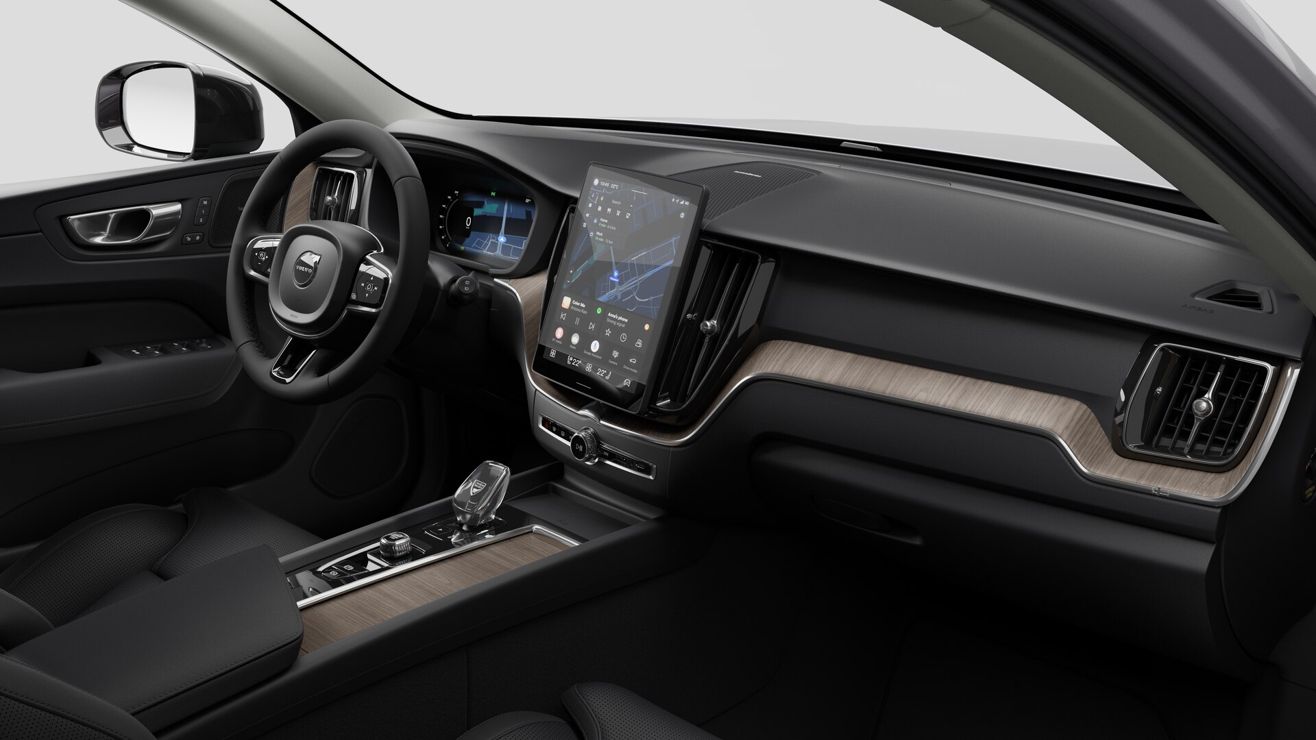 Vue intérieure d’une Volvo montrant le tableau de bord, le volant, la console centrale et l’écran d’affichage numérique sur un fond de studio uni.