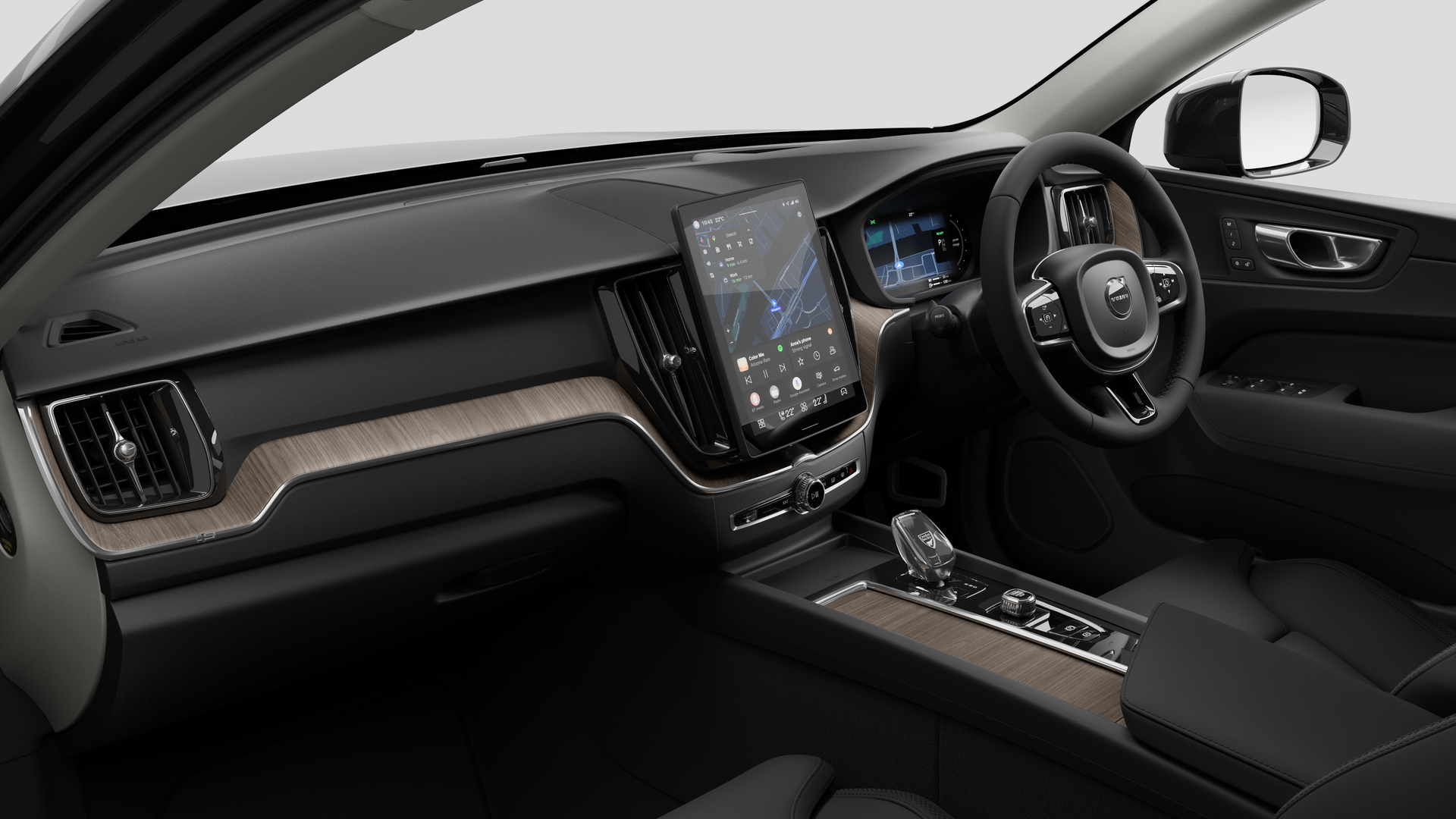 Interior view of a Volvo car showing the dashboard, steering wheel, center console, and digital display screen in a plain studio background.