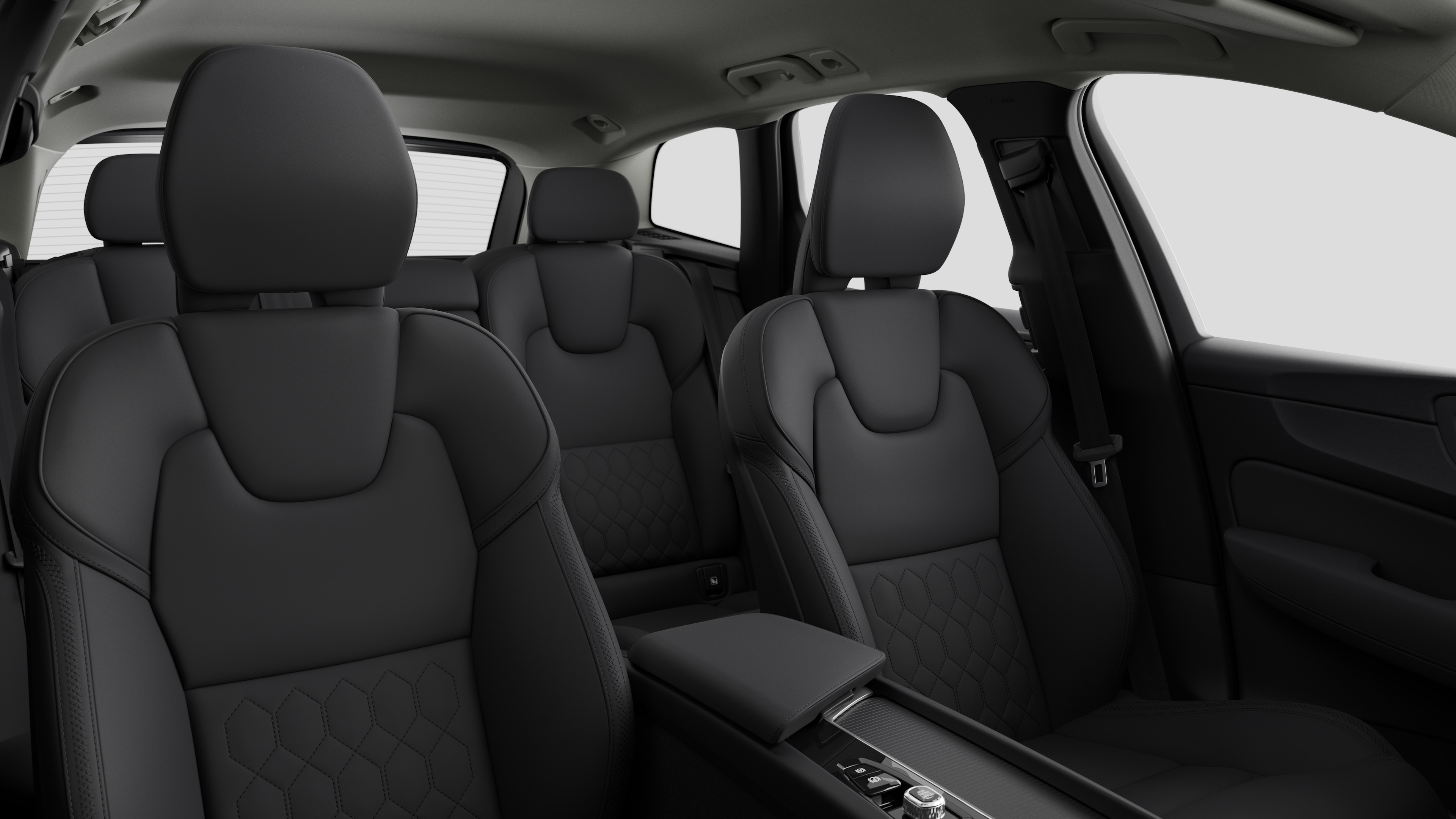 Volvo car interior showing rear passenger seats and center console in plain studio background.