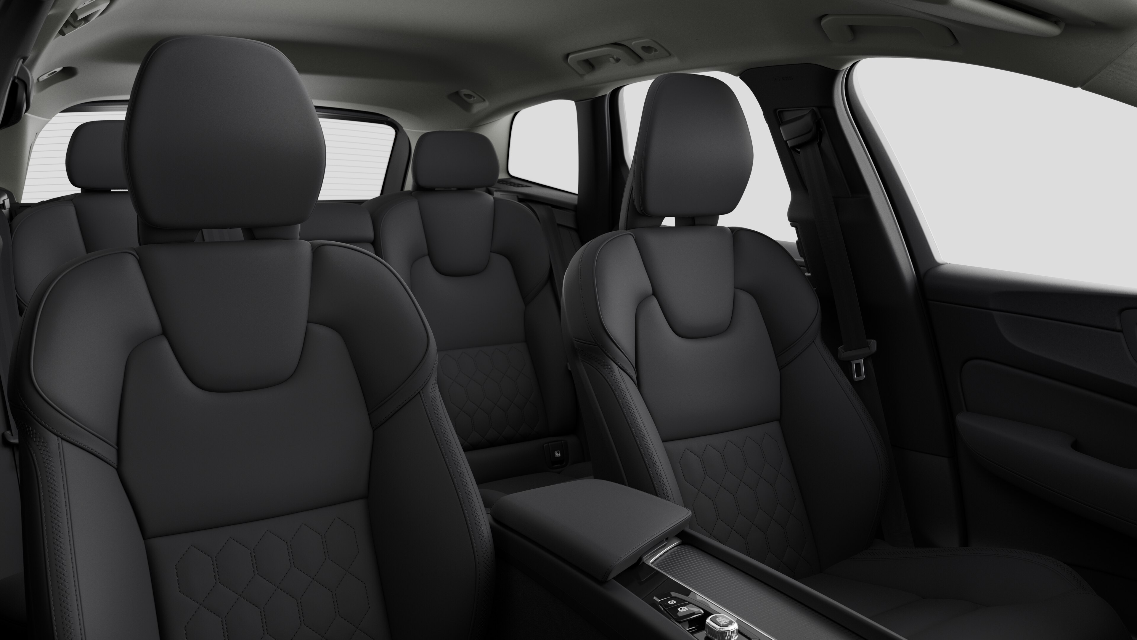 Volvo car interior showing rear passenger seats and center console in plain studio background.