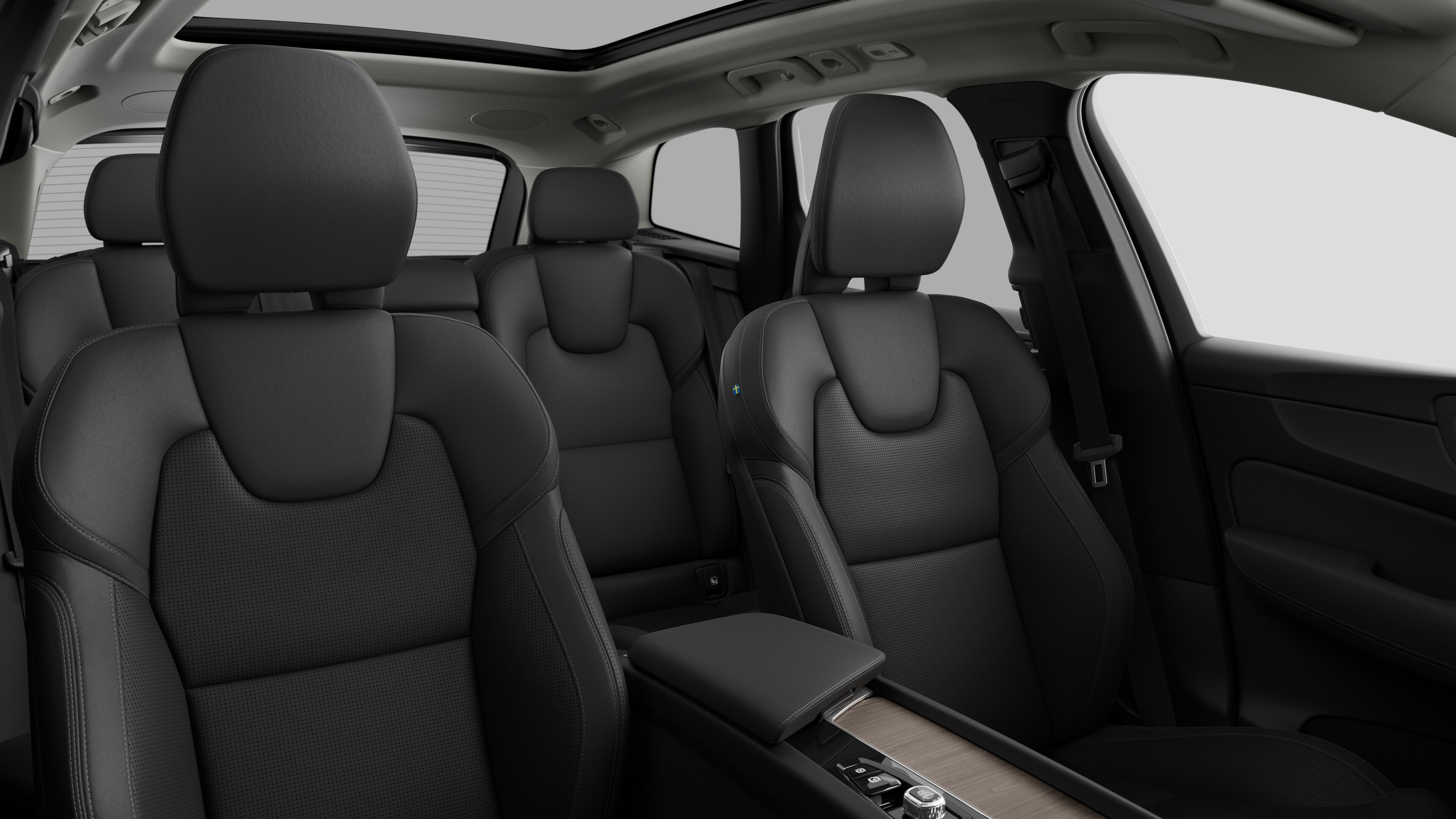Volvo car interior showing rear passenger seats and center console in plain studio background.