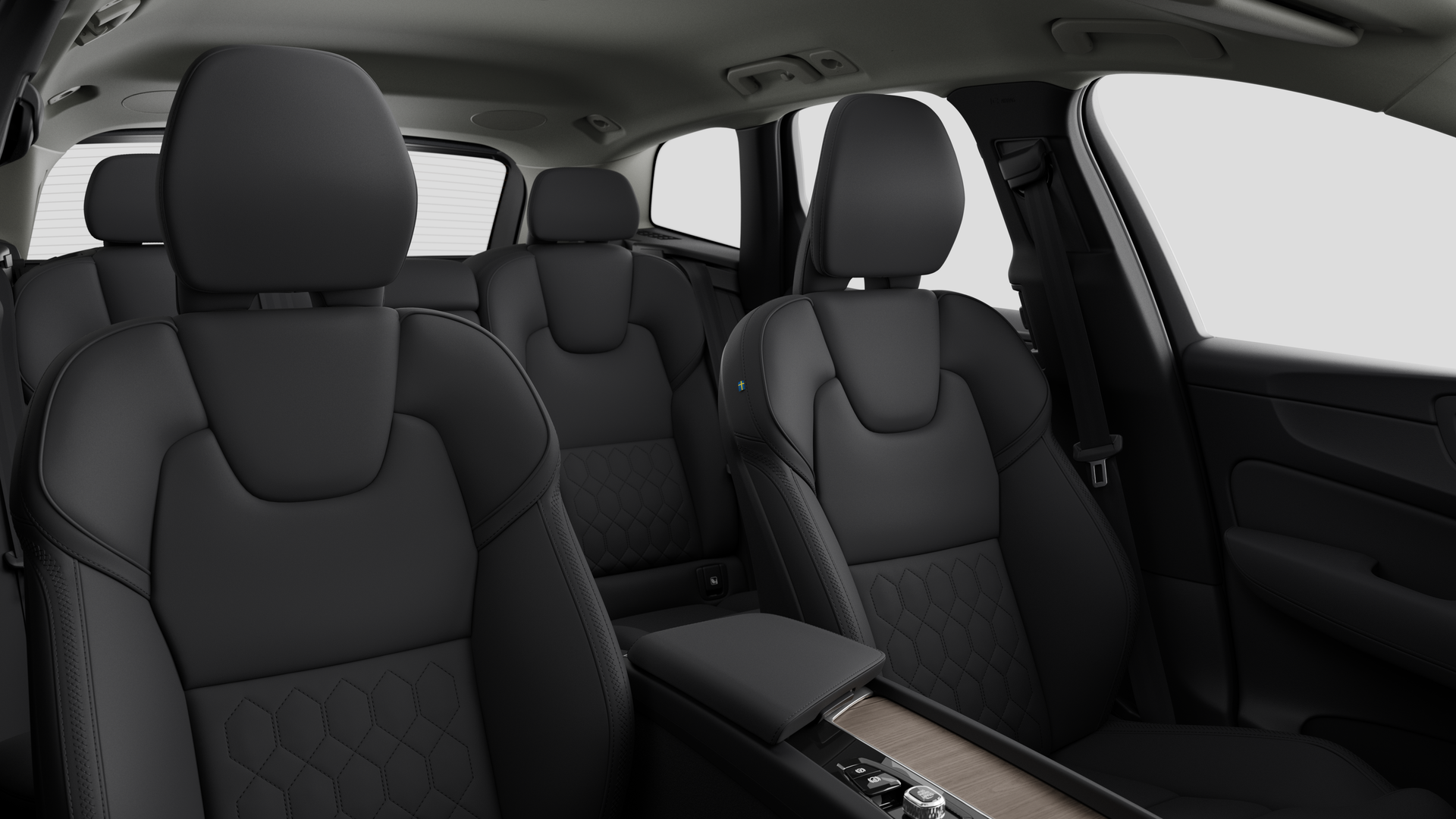 Volvo car interior showing rear passenger seats and center console in plain studio background.
