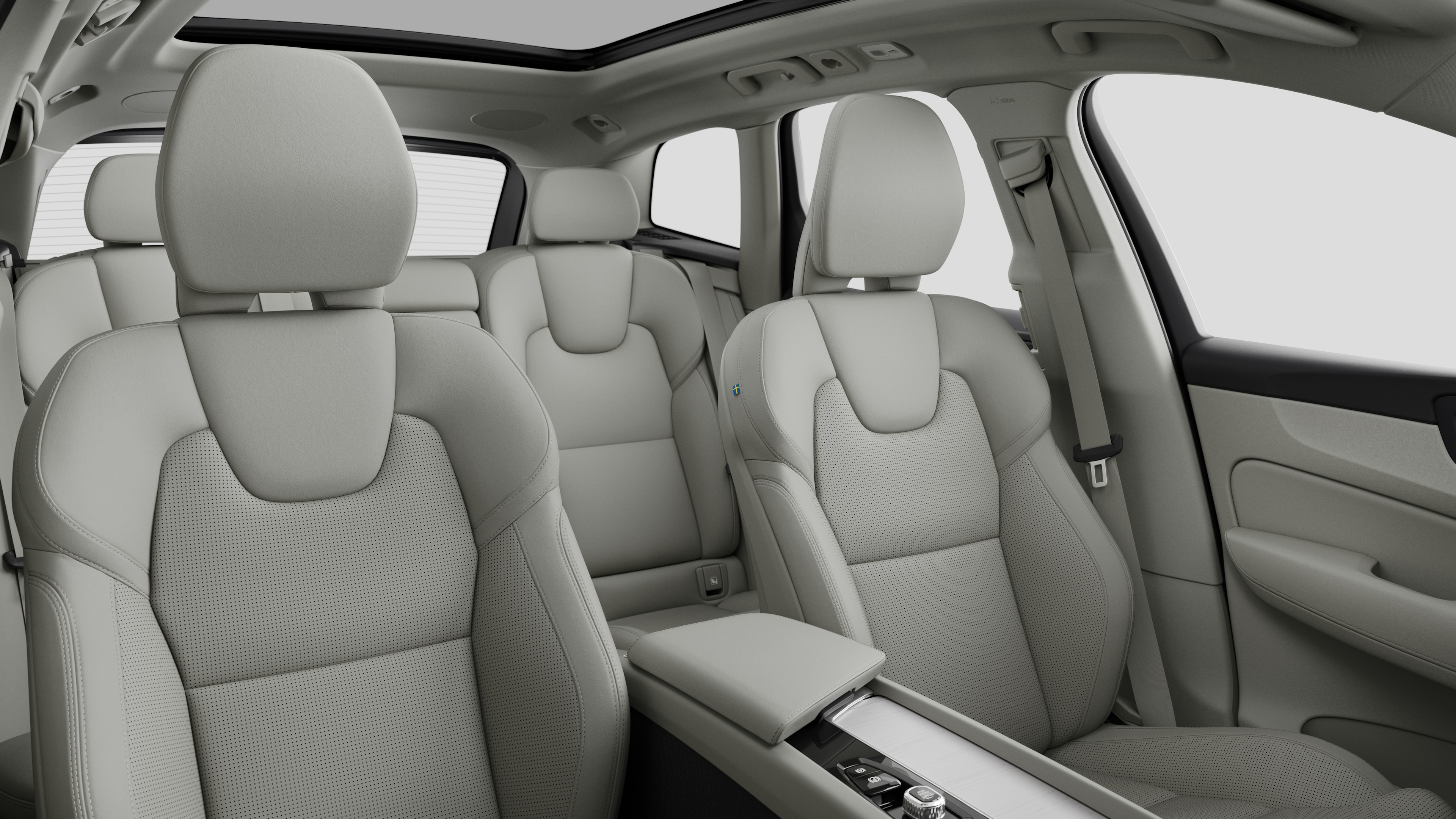 Volvo car interior showing rear passenger seats and center console in plain studio background.