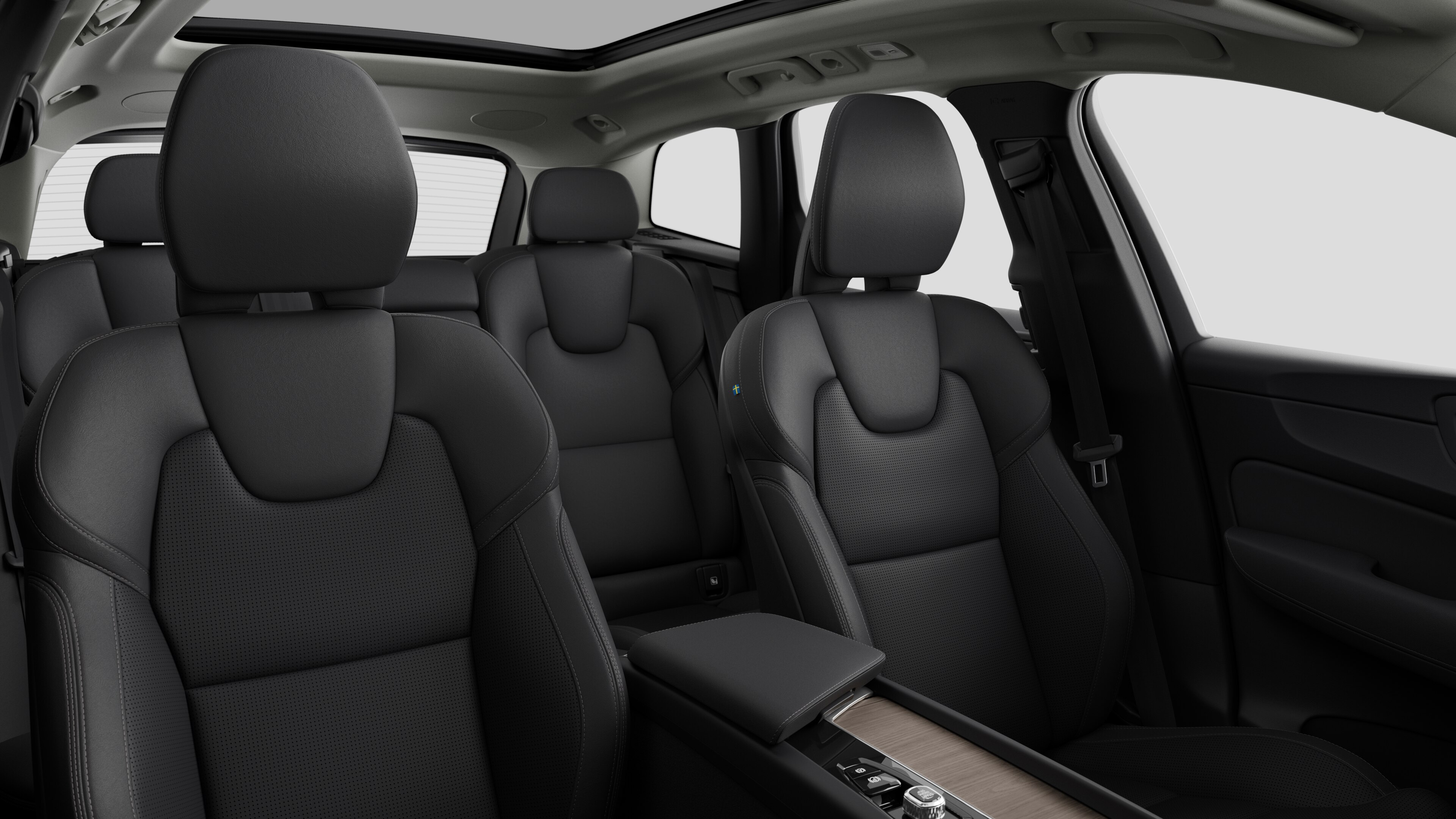Volvo car interior showing rear passenger seats and center console in plain studio background.