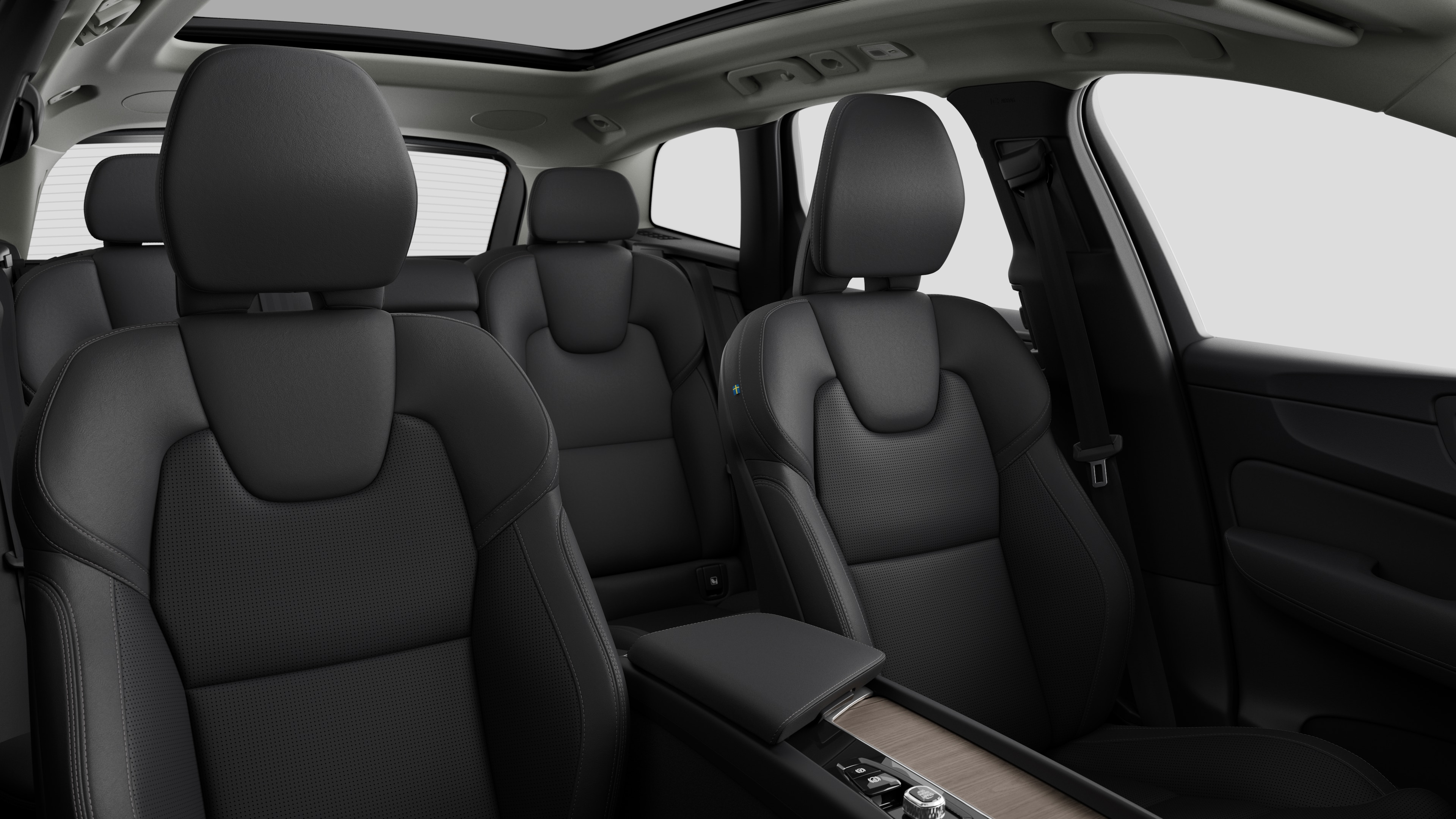 Volvo car interior showing rear passenger seats and center console in plain studio background.