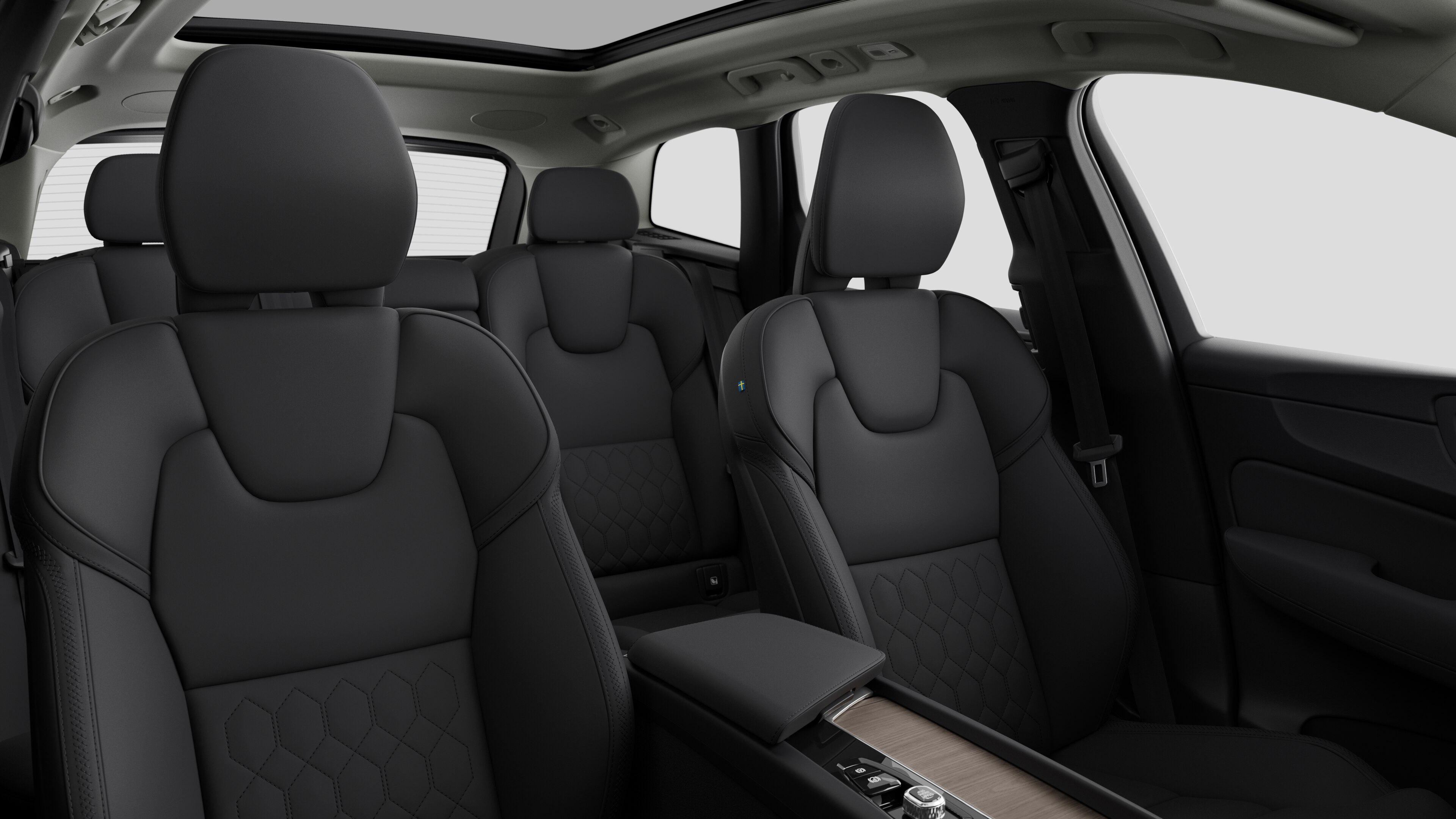 Volvo car interior showing rear passenger seats and center console in plain studio background.