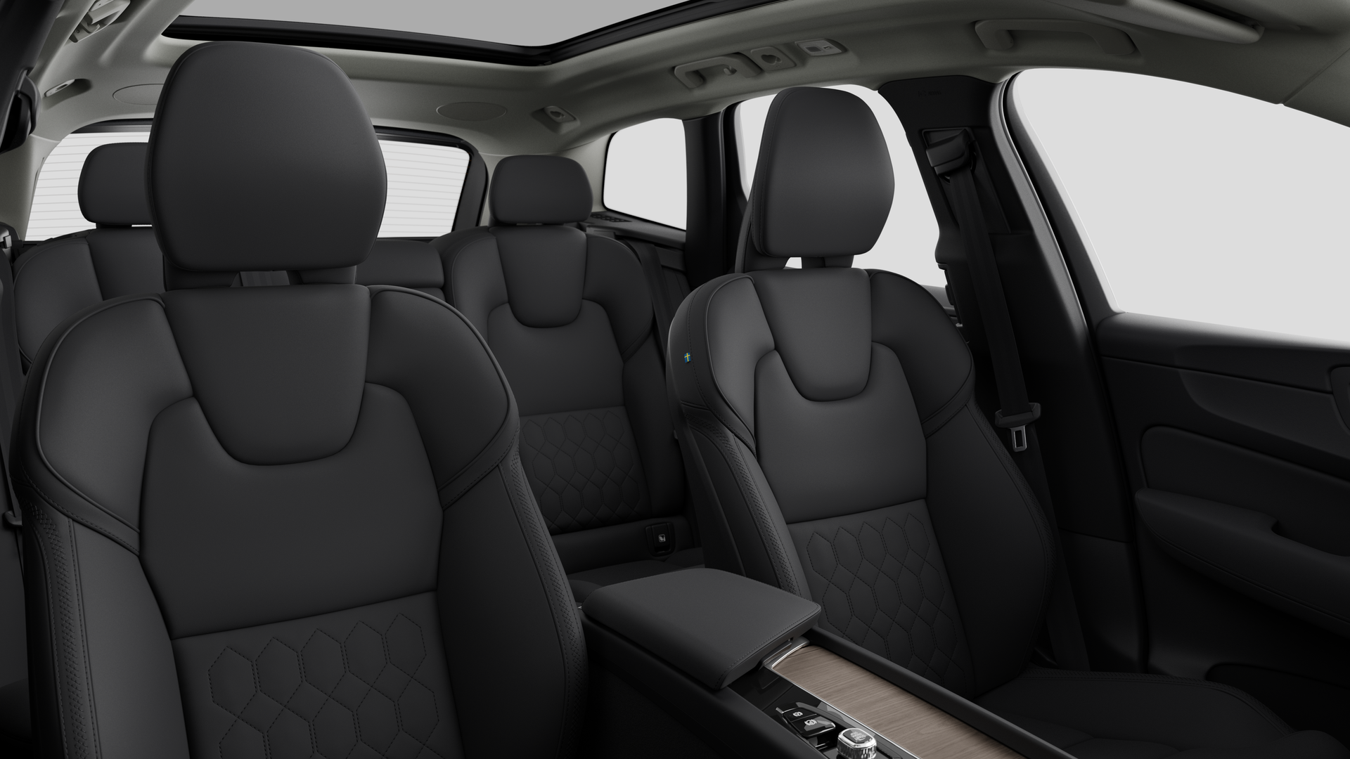 Volvo car interior showing rear passenger seats and center console in plain studio background.