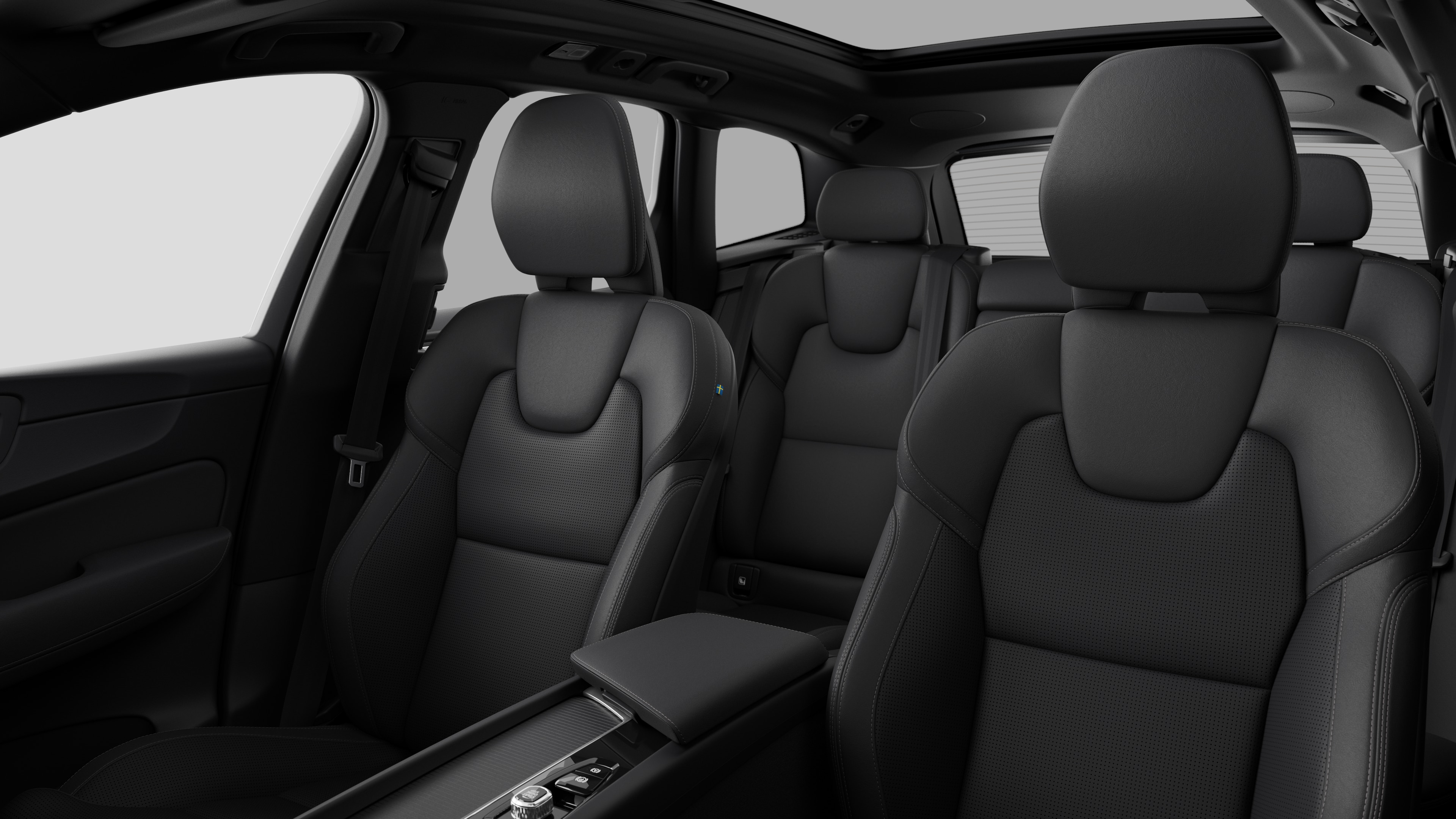 Volvo car interior showing rear passenger seats and center console in plain studio background.