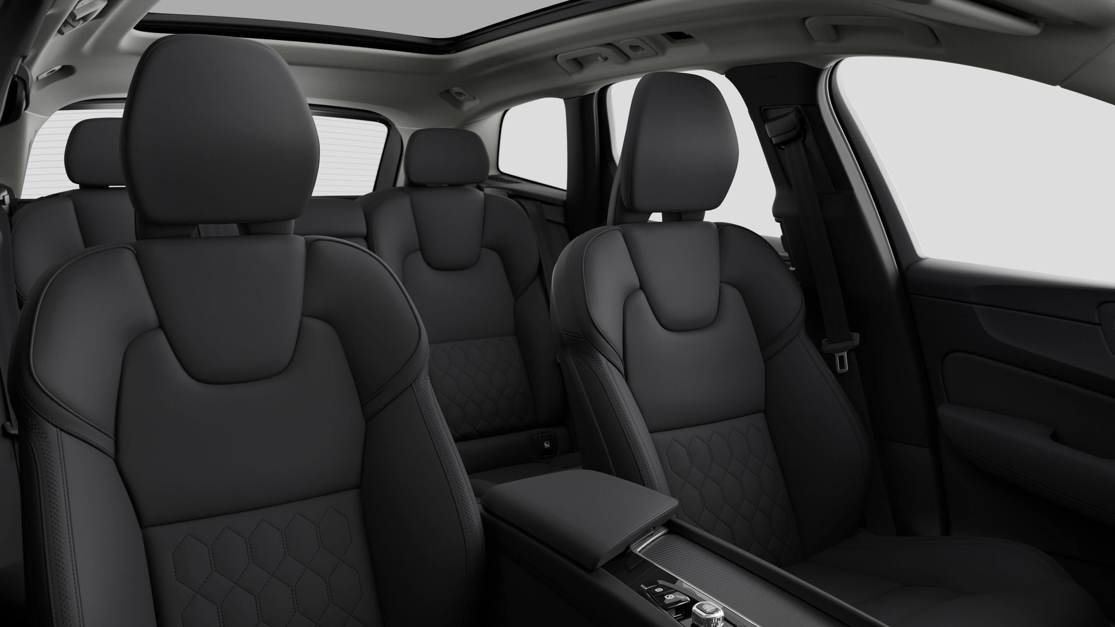 Volvo car interior showing rear passenger seats and center console in plain studio background.