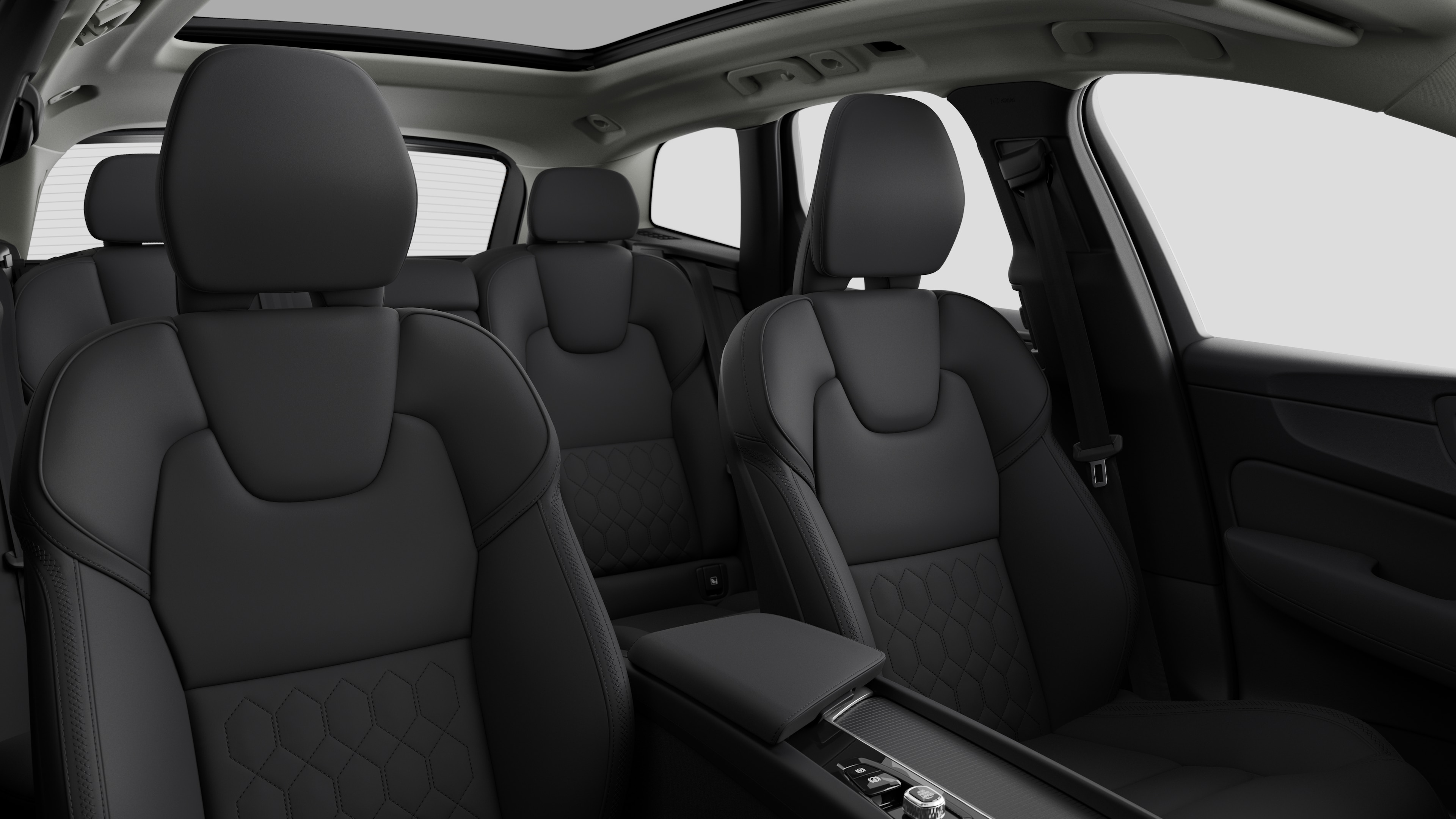 Volvo car interior showing rear passenger seats and center console in plain studio background.